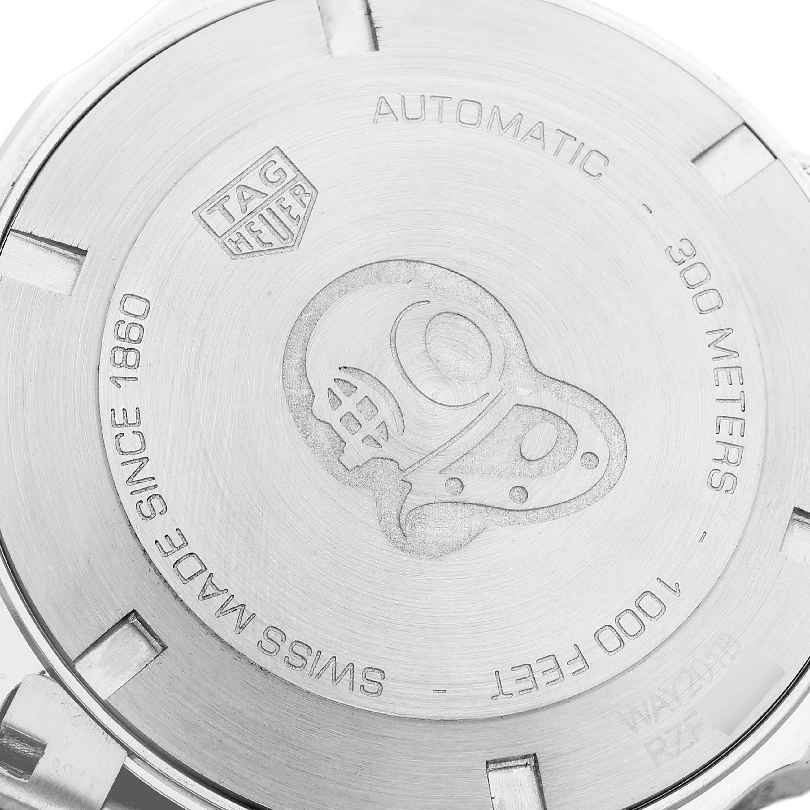 The image shows the engraved back case of a Tag Heuer Aquaracer WAY201B Men's Stainless Steel Blue Dial WAY201B Men's Stainless Steel Blue Dial watch, featuring a diving helmet motif.