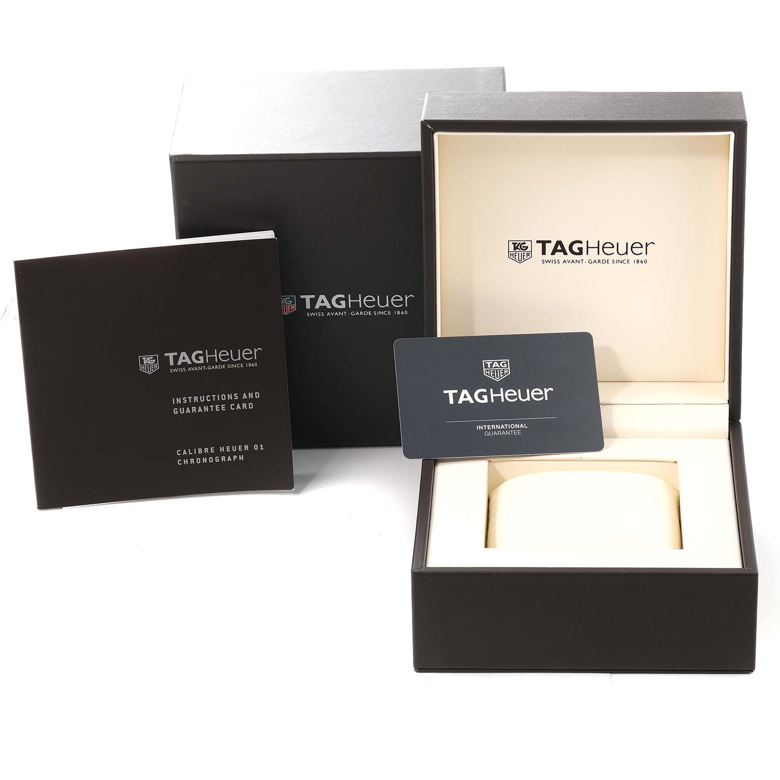 The image shows the packaging, instruction booklet, and guarantee card for a Tag Heuer Carrera CAR2A1Z Men's Stainless Steel Black Dial CAR2A1Z Men's Stainless Steel Black Dial watch.