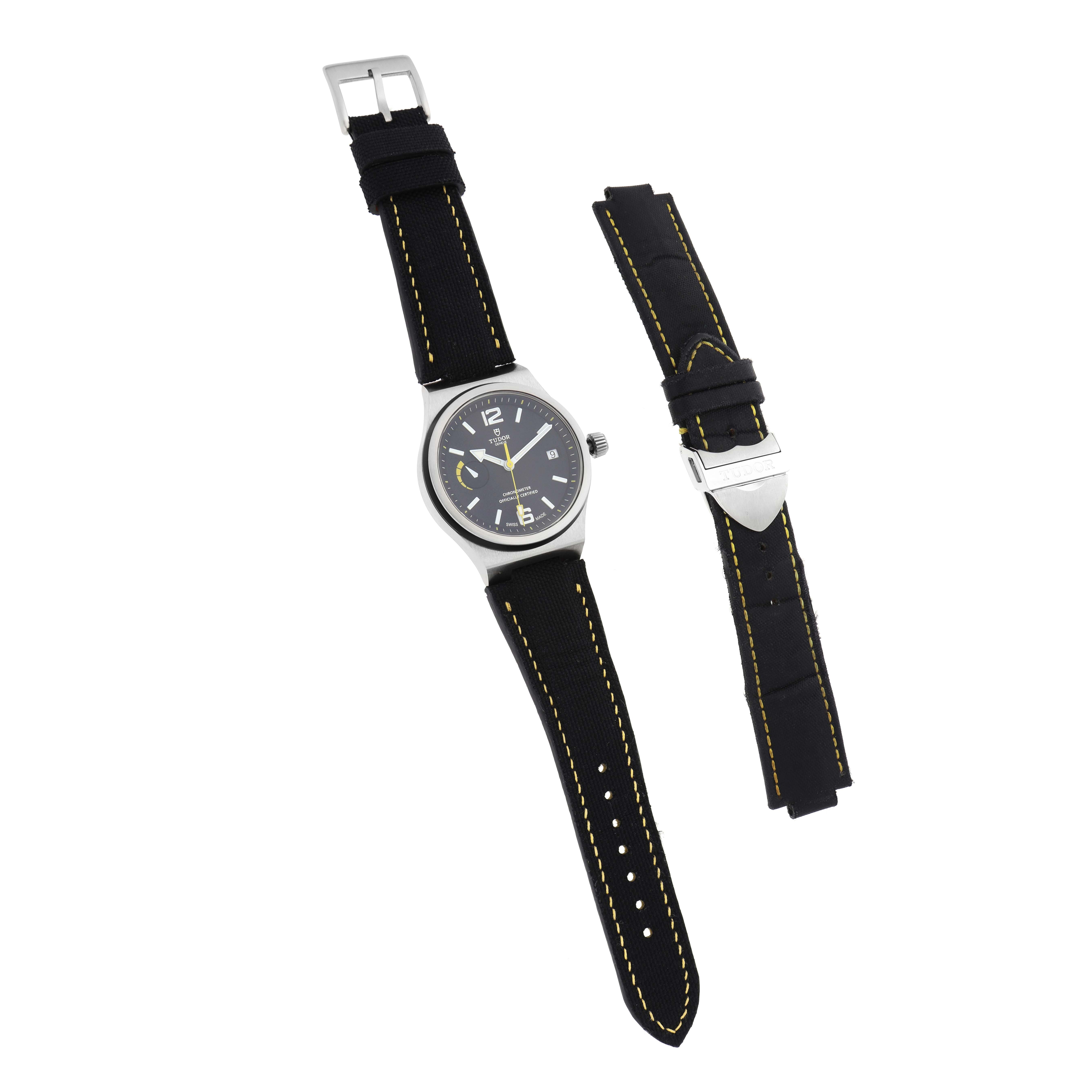 The Tudor Pelagos 91210N Men
s Stainless Steel Black Dial watch is shown from the front with its black strap and an additional strap accessory alongside.