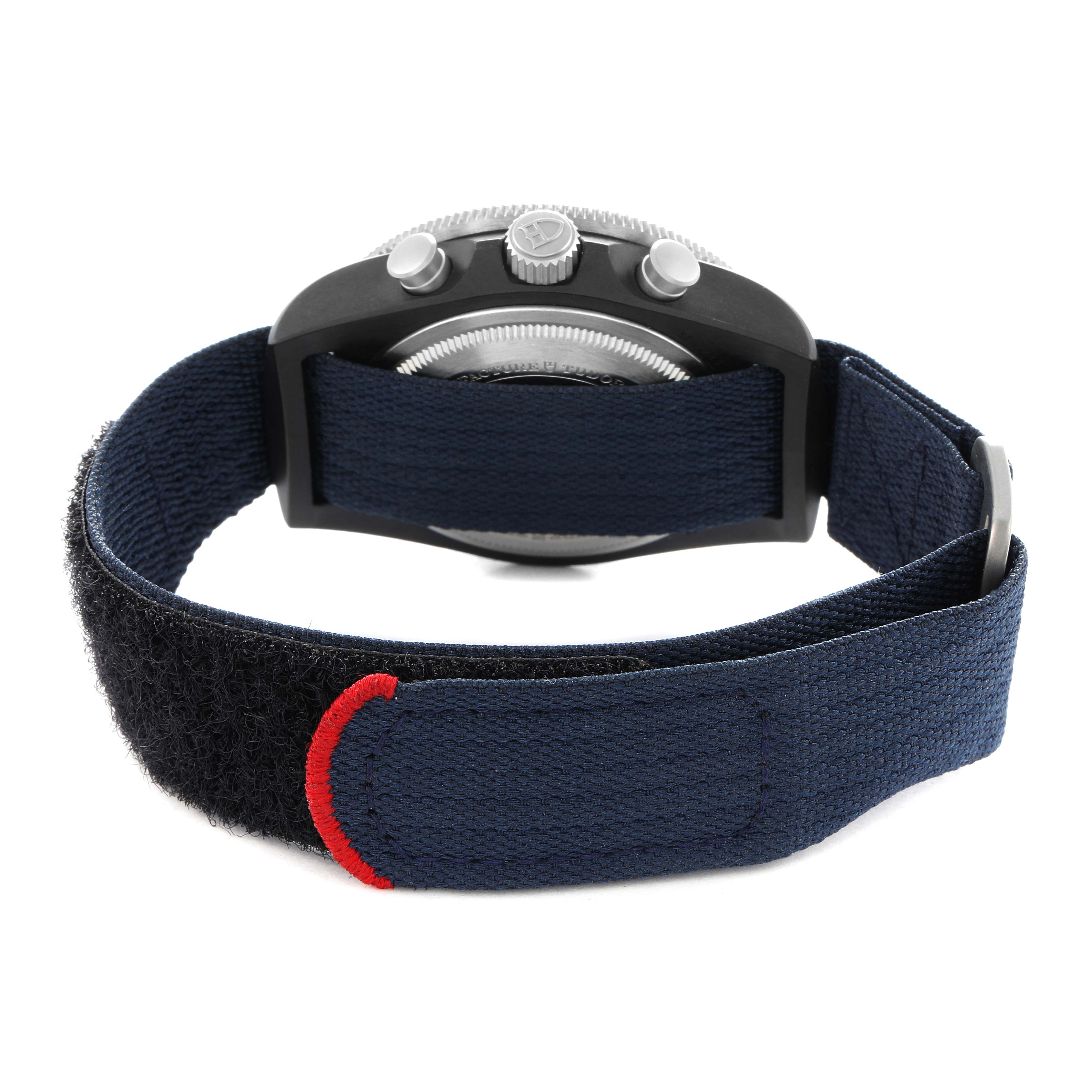 The Tudor Pelagos 25827KN Men
s Stainless Steel Blue Dial watch is shown from the back, highlighting the case, crown, and fabric strap with a Velcro closure.