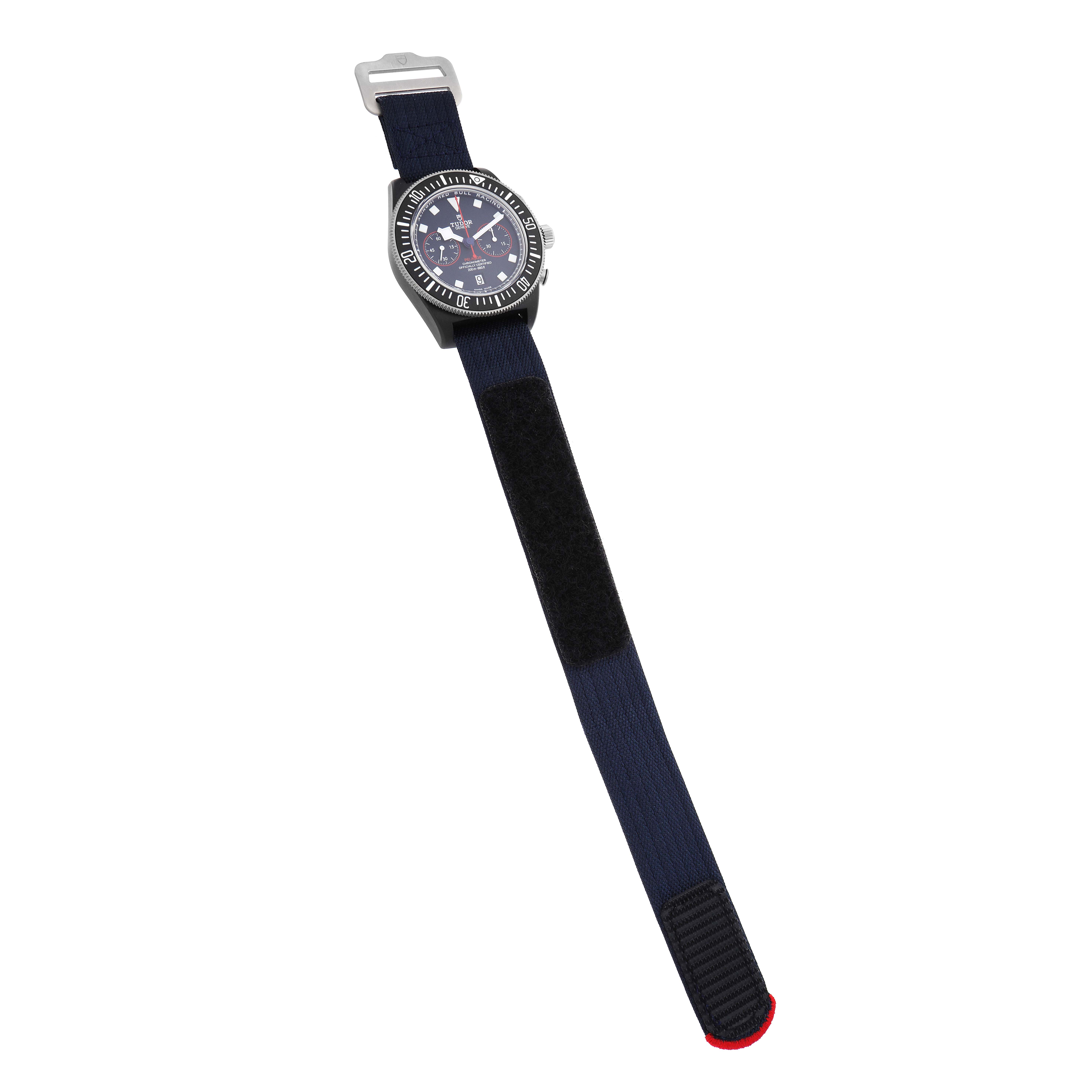 The image shows a Tudor Pelagos 25827KN Men
s Stainless Steel Blue Dial watch from a top view, displaying the dial, bezel, case, and fabric strap.