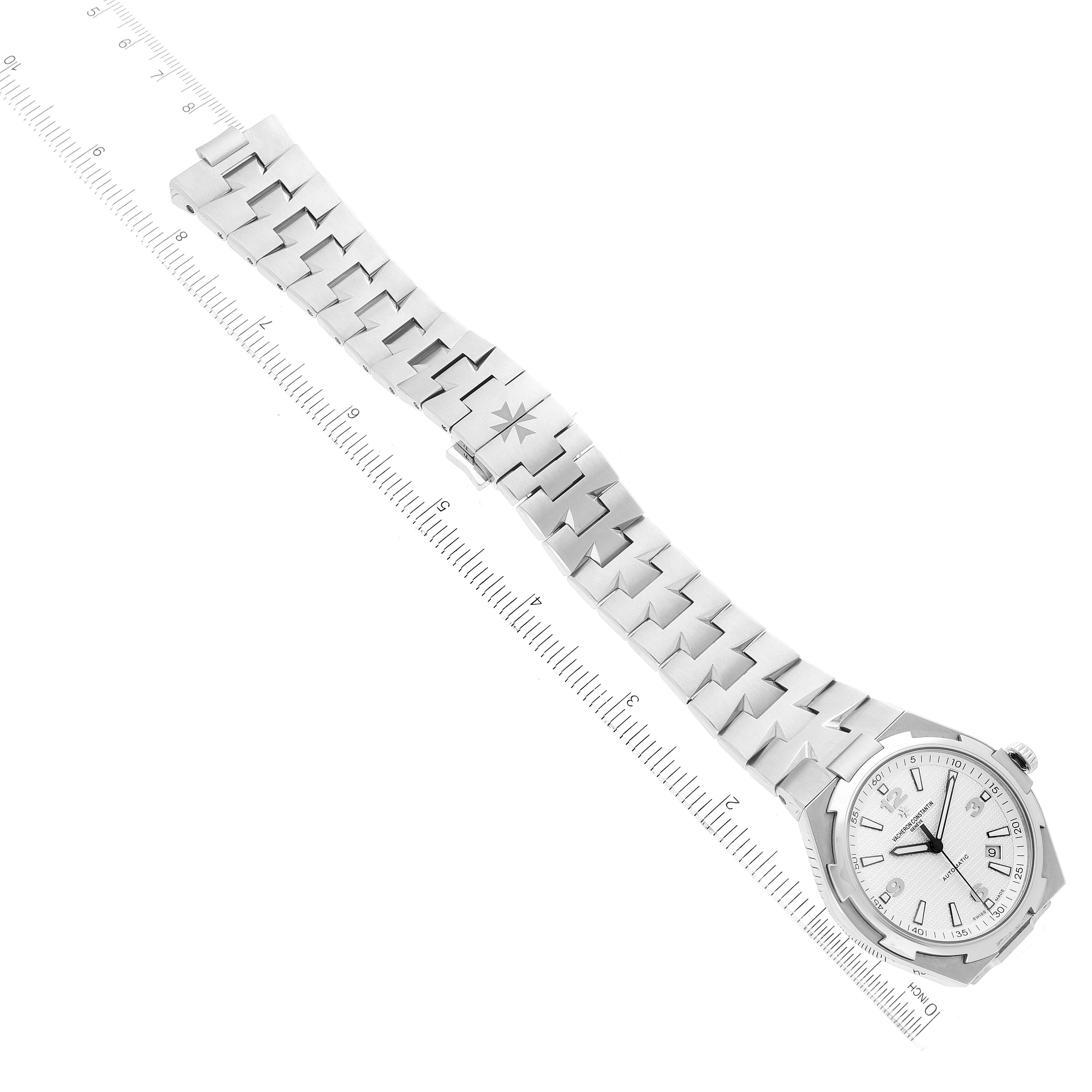 The image shows an overhead view of the Vacheron Constantin Overseas 47040B01A-9093 Men's Stainless Steel Silver Dial 47040B01A-9093 Men's Stainless Steel Silver Dial watch, displaying its dial, bezel, and entire bracelet.