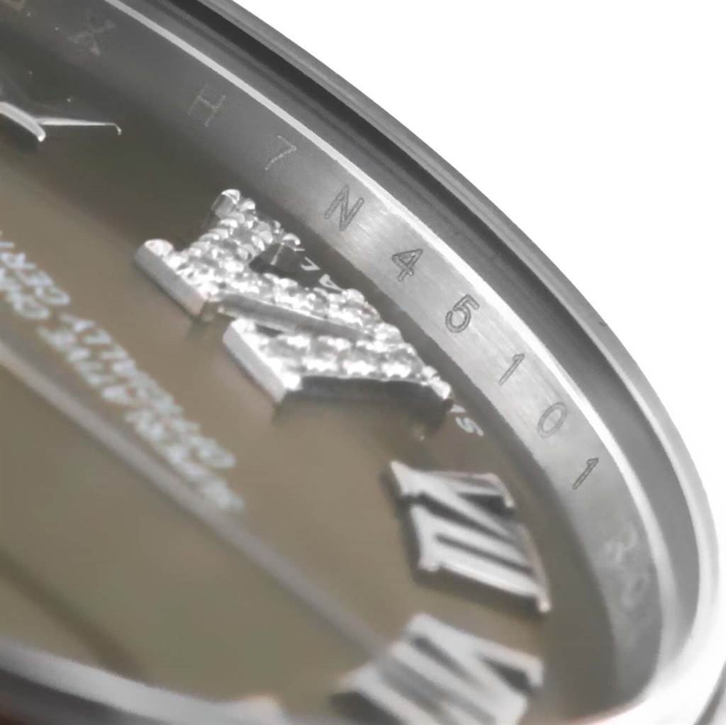 This close-up angle of the Rolex 178274 Women's Stainless Steel Brown Dial 178274 Women's Stainless Steel Brown Dial Datejust Midsize 178274 shows the bezel and part of the diamond-studded Roman numerals on the dial.