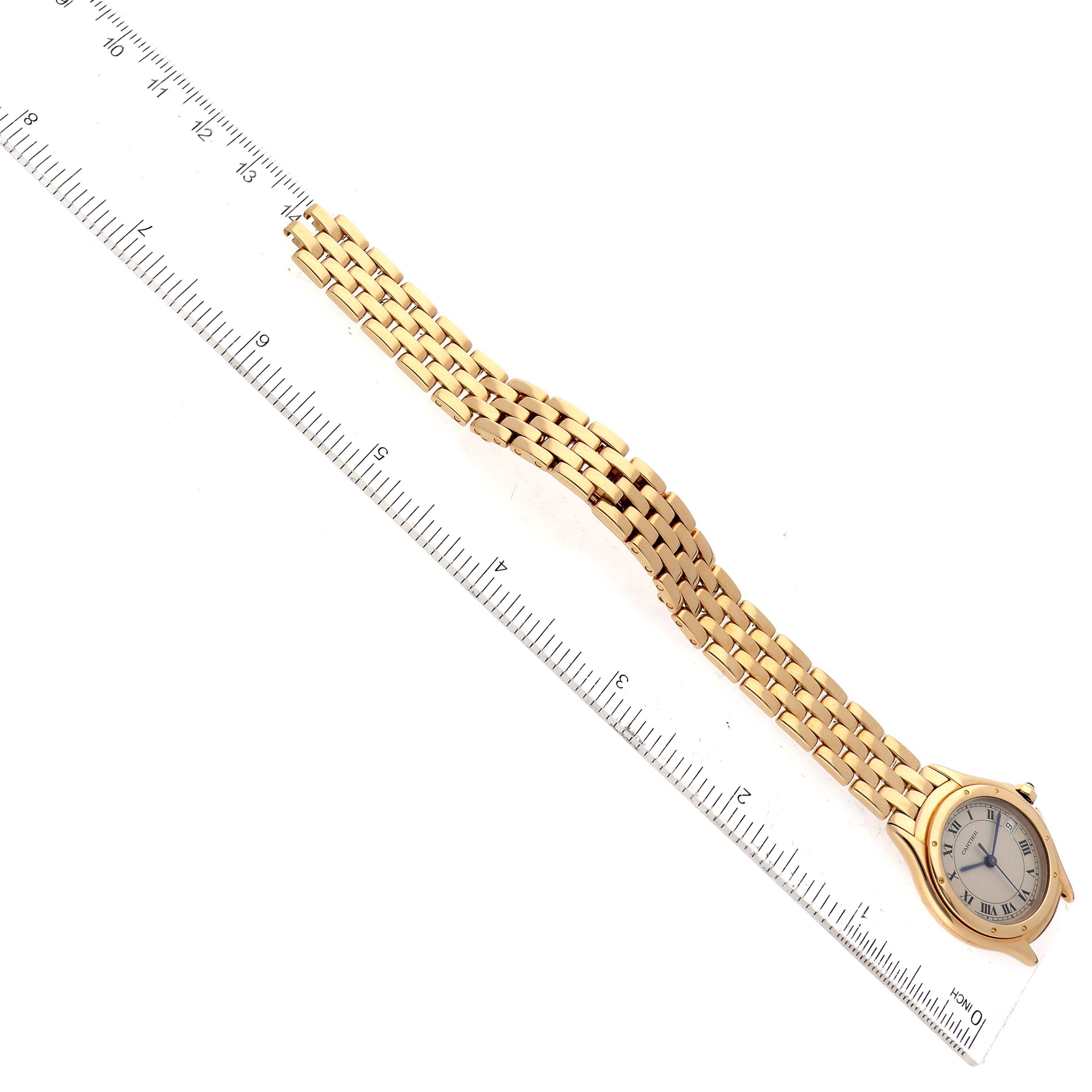 The image shows the Cartier Panthere 887906 Women's Yellow Gold Silver Dial 887906 Women's Yellow Gold Silver Dial model watch placed diagonally with its entire bracelet and face visible, alongside a ruler for scale.