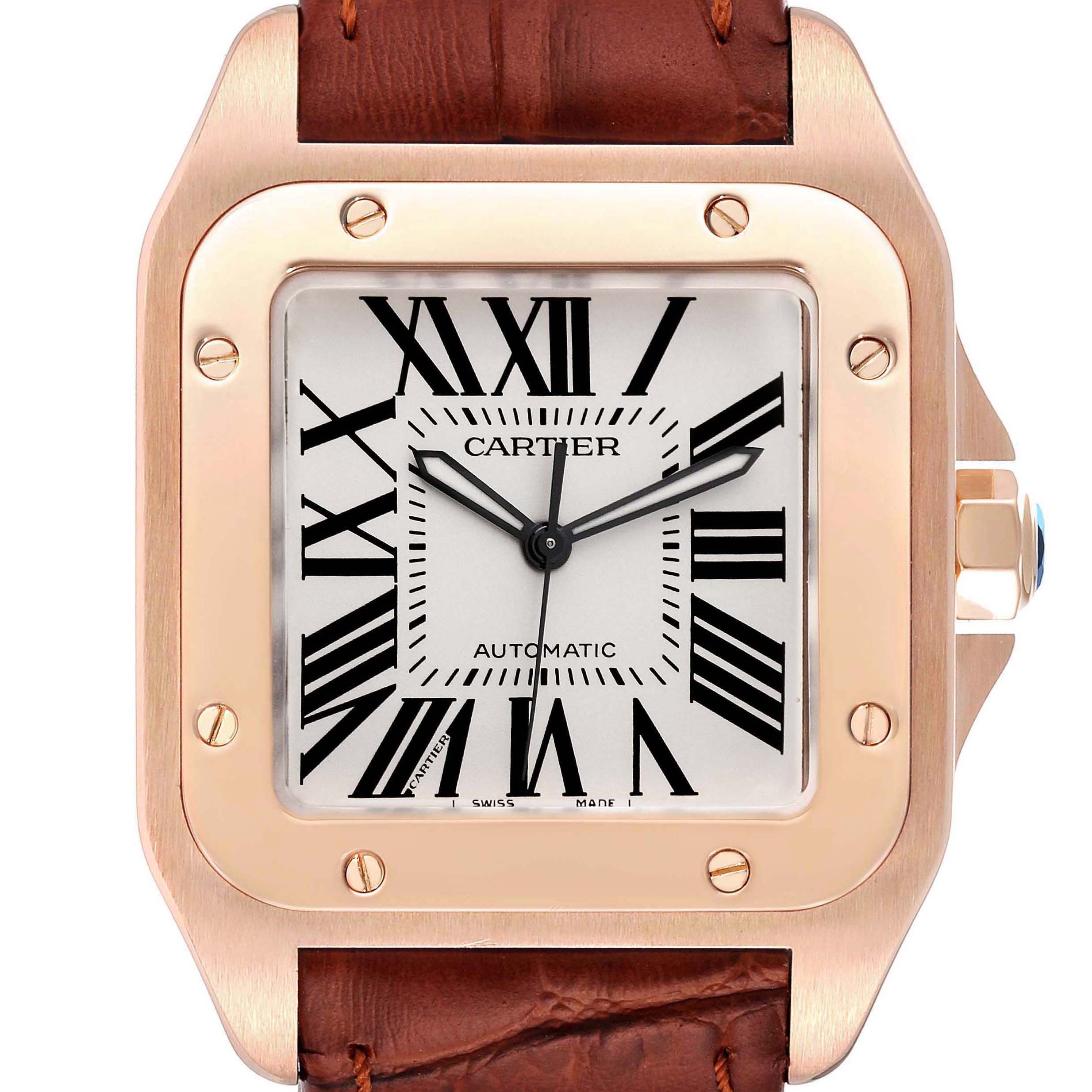 This image shows a close-up of the Cartier Santos W20095Y1 Men's Rose Gold Silver Dial W20095Y1 Men's Rose Gold Silver Dial watch face and bezel with a leather strap.
