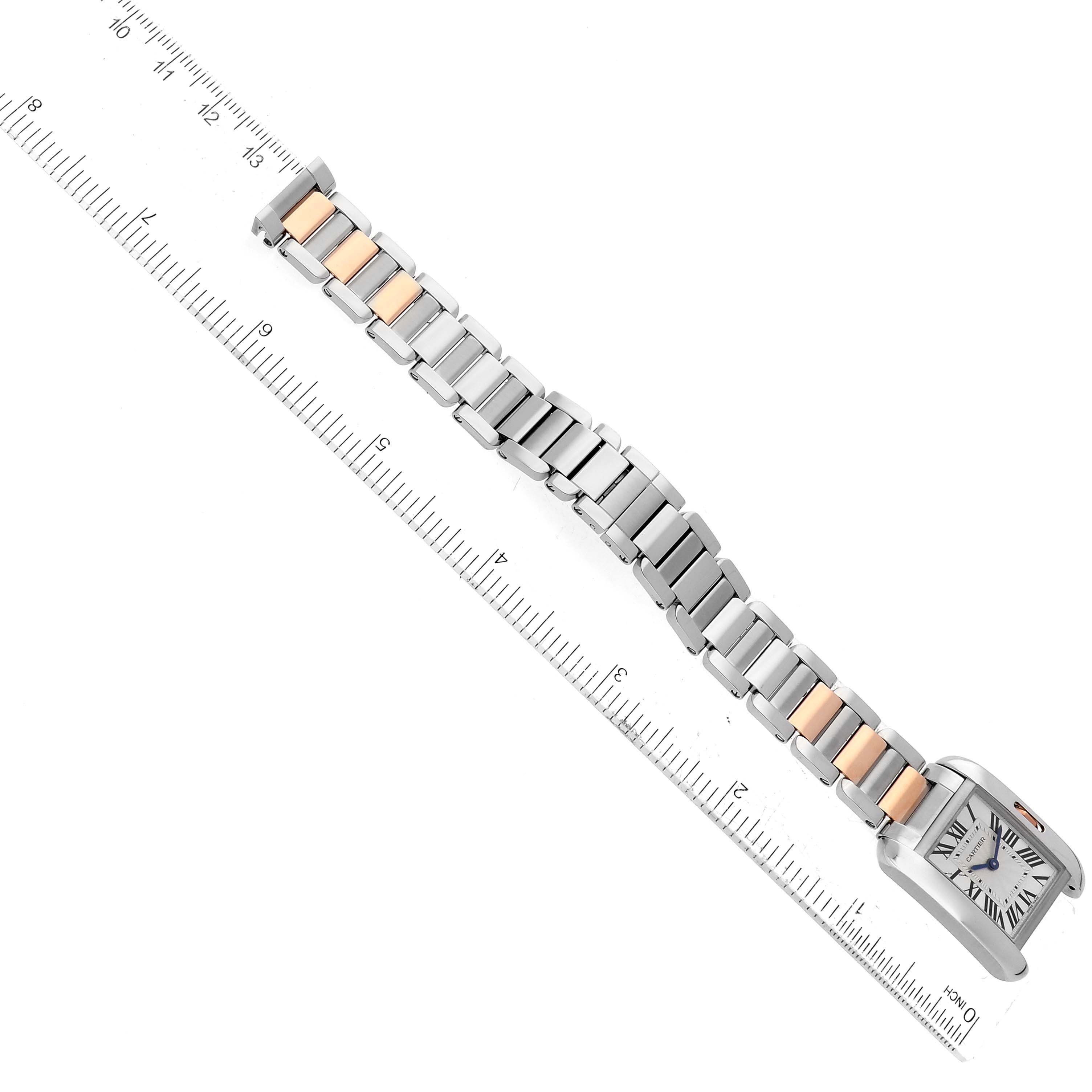 The image shows a Cartier Tank Anglaise W5310019 Women
s Steel and Gold (two tone) Silver Dial W5310019 Women
s Steel and Gold (two tone) Silver Dial watch laid flat against a ruler, highlighting its two-tone bracelet and square face.