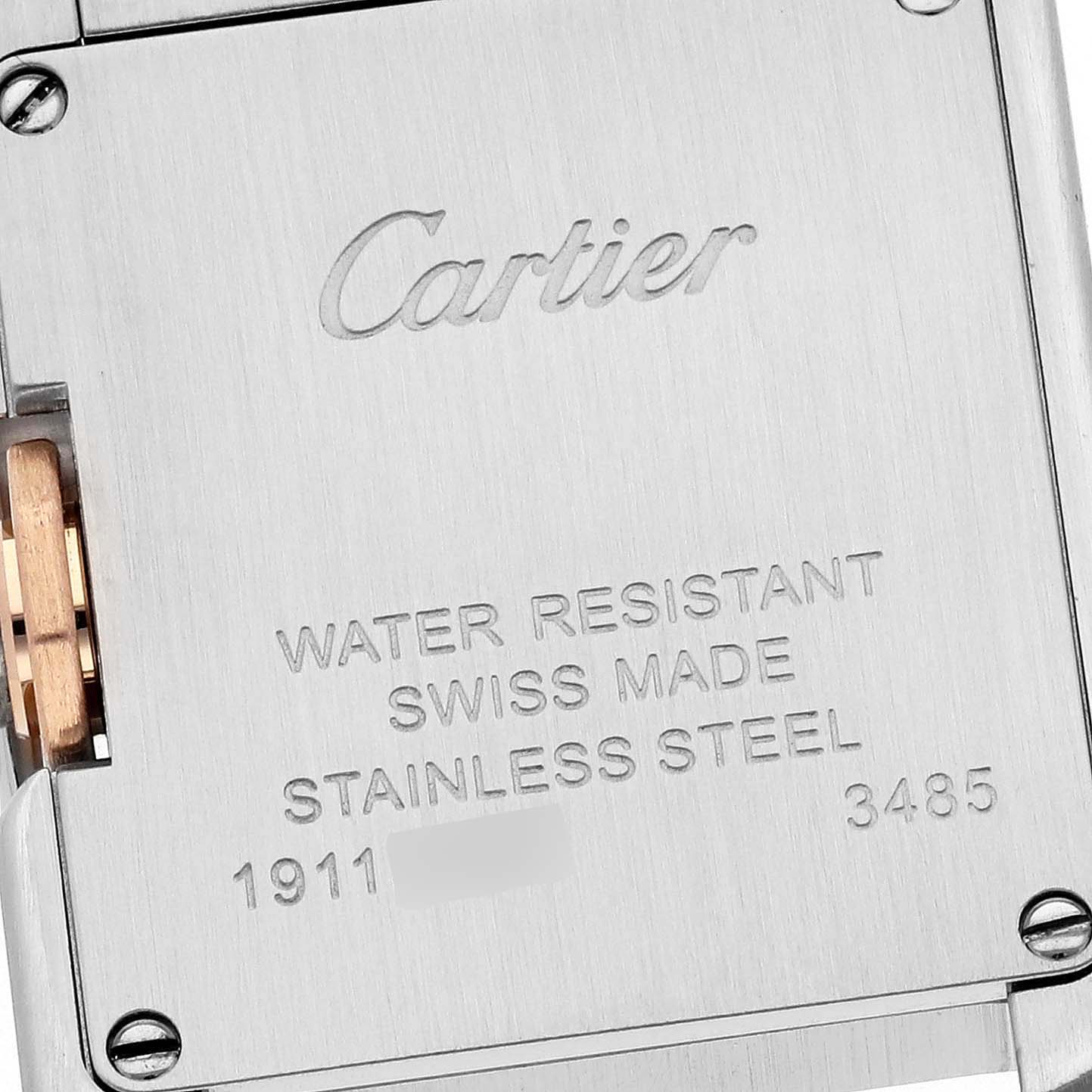 This image shows the stainless steel case back of a Cartier Tank Anglaise W5310019 Women
s Steel and Gold (two tone) Silver Dial W5310019 Women
s Steel and Gold (two tone) Silver Dial watch, including engraved text and some screws.