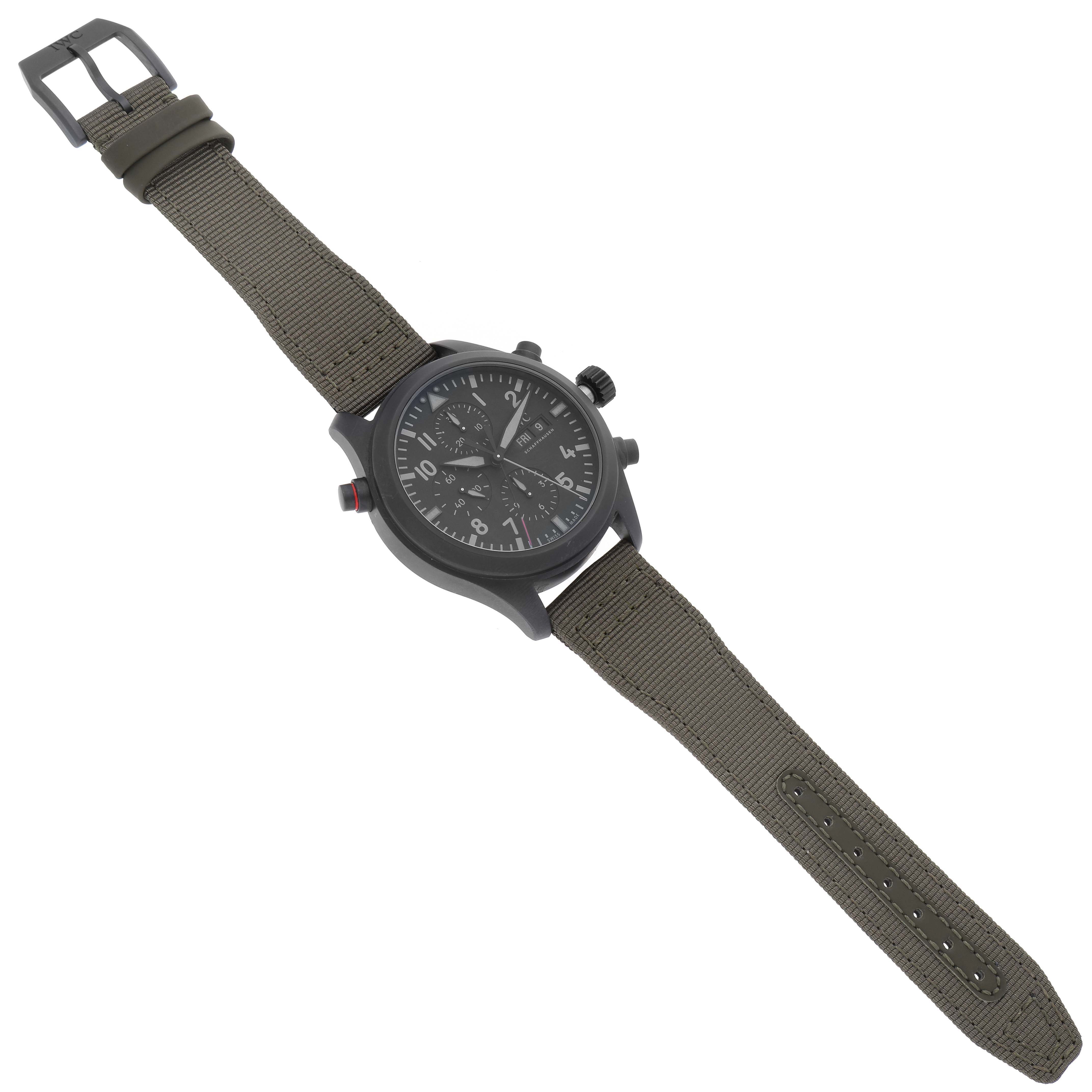 The IWC Pilot IW371815 Men's Titanium Black Dial IW371815 Men's Titanium Black Dial model watch is shown from a top-down angle, featuring its dial, bezel, buttons, and fabric strap.