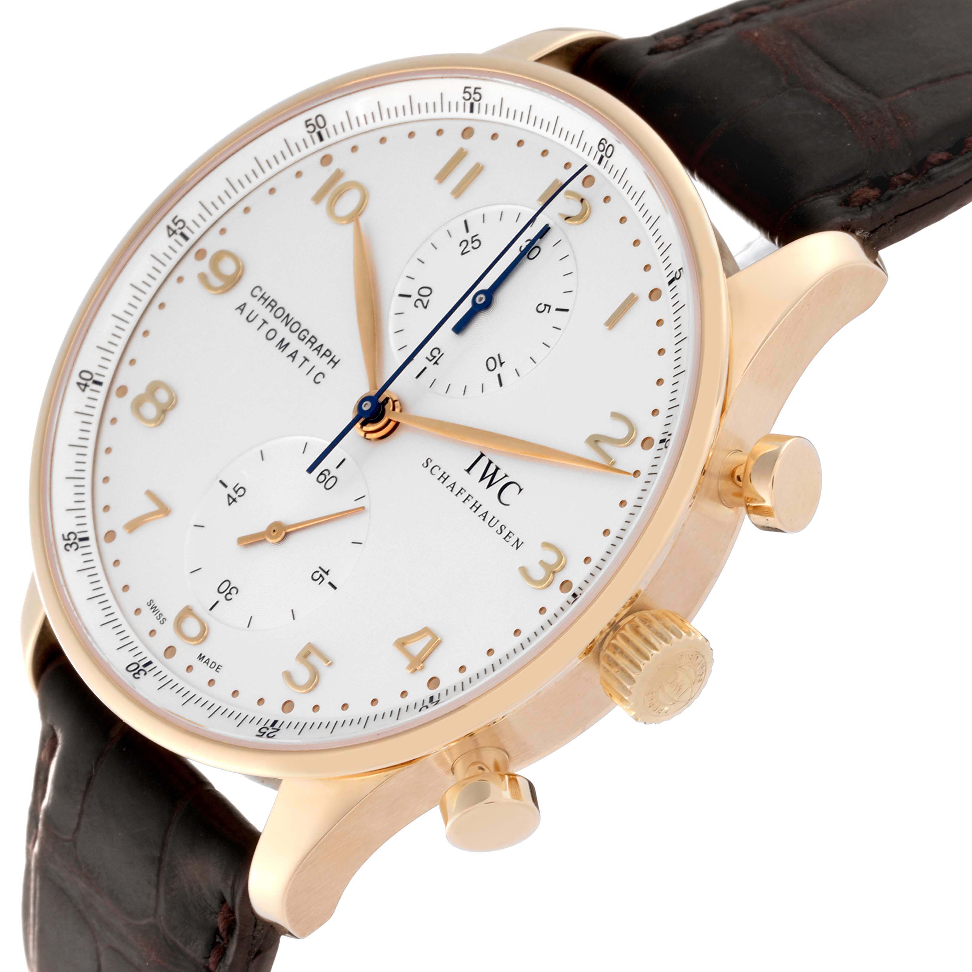 The IWC Portuguese IW371402 Men's Rose Gold Silver Dial IW371402 Men's Rose Gold Silver Dial model watch is shown at an angled view highlighting the gold case, chronograph dials, crown, and leather strap.