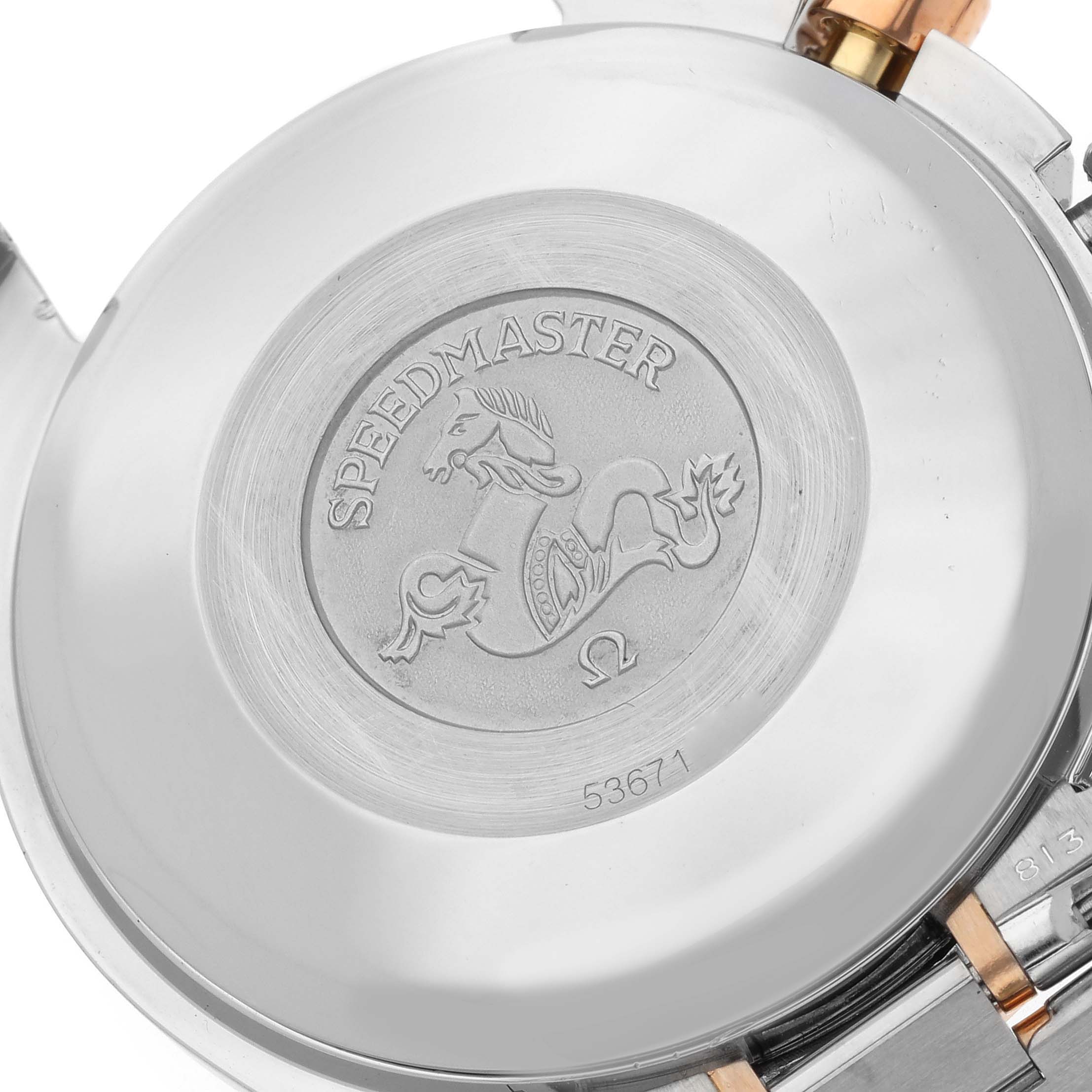 This image shows the back case of an Omega Speedmaster 3316.50 Men's Steel and Gold (two tone) Black Dial 3316.50 Men's Steel and Gold (two tone) Black Dial watch, highlighting the engraved emblem and model details.