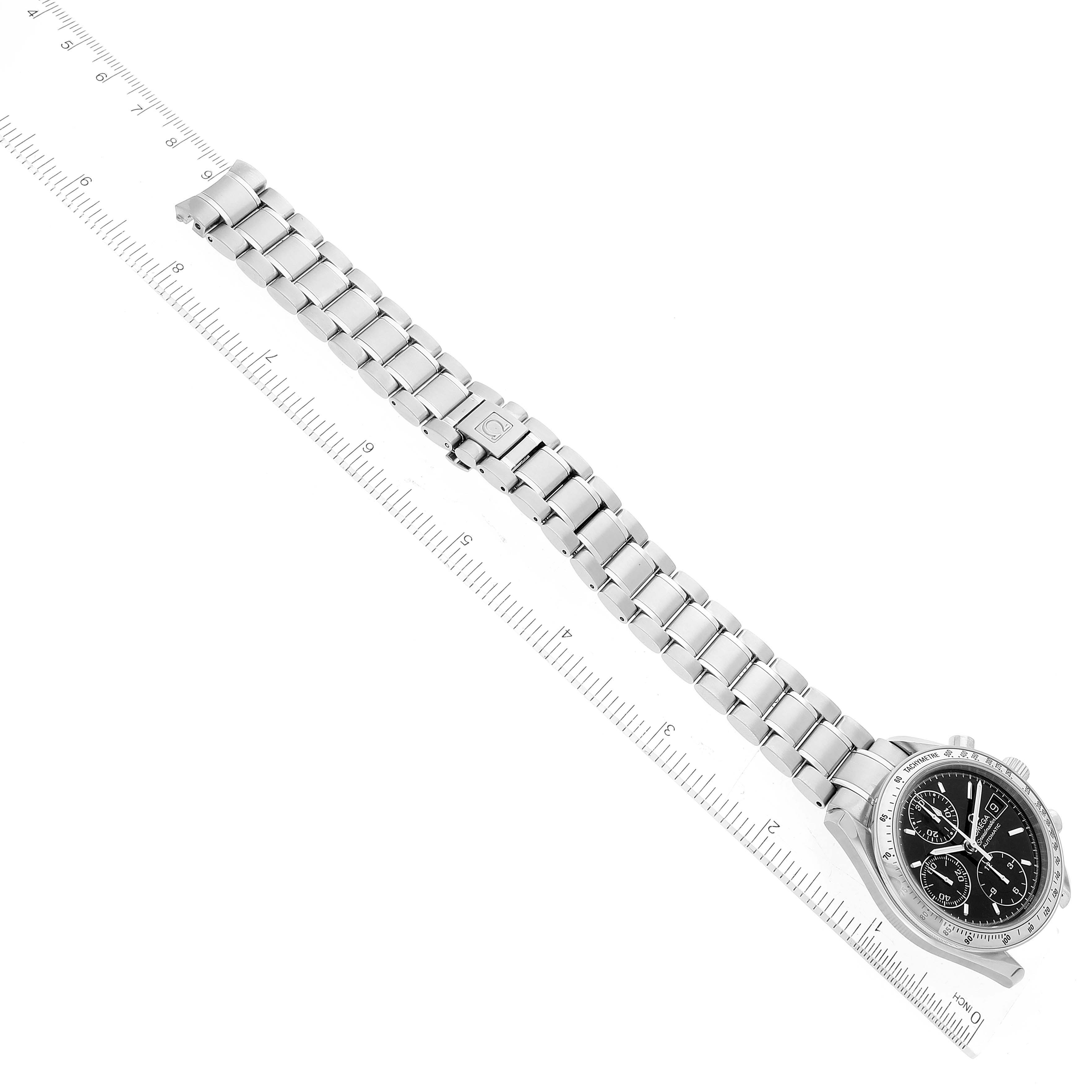 The image shows an Omega Speedmaster 3513.50.00 Men
s Stainless Steel Black Dial 3513.50.00 Men
s Stainless Steel Black Dial watch with a stainless steel bracelet laid flat next to a ruler for scale.