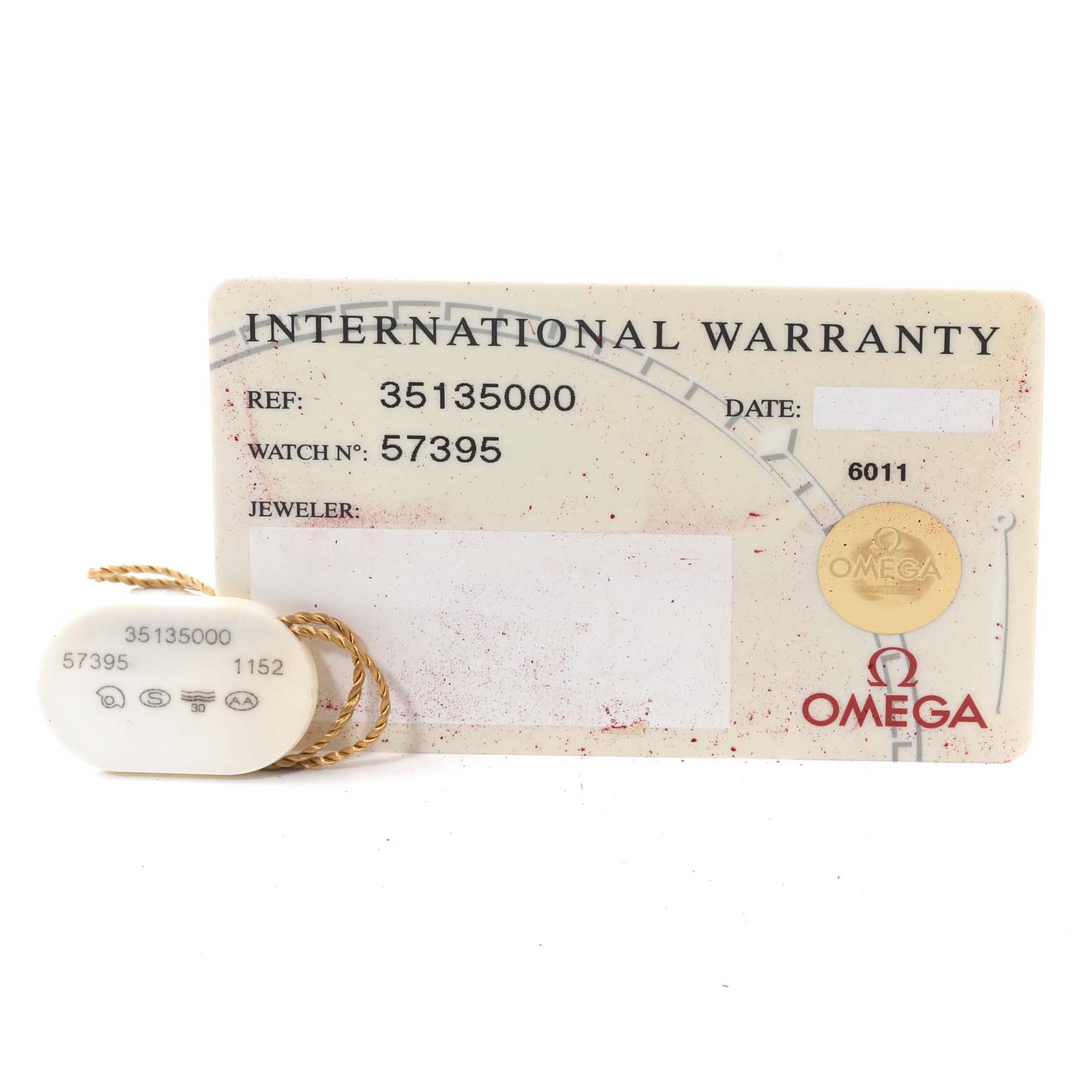 The image shows an Omega Speedmaster 3513.50.00 Men
s Stainless Steel Black Dial 3513.50.00 Men
s Stainless Steel Black Dial international warranty card and a tag with reference numbers.