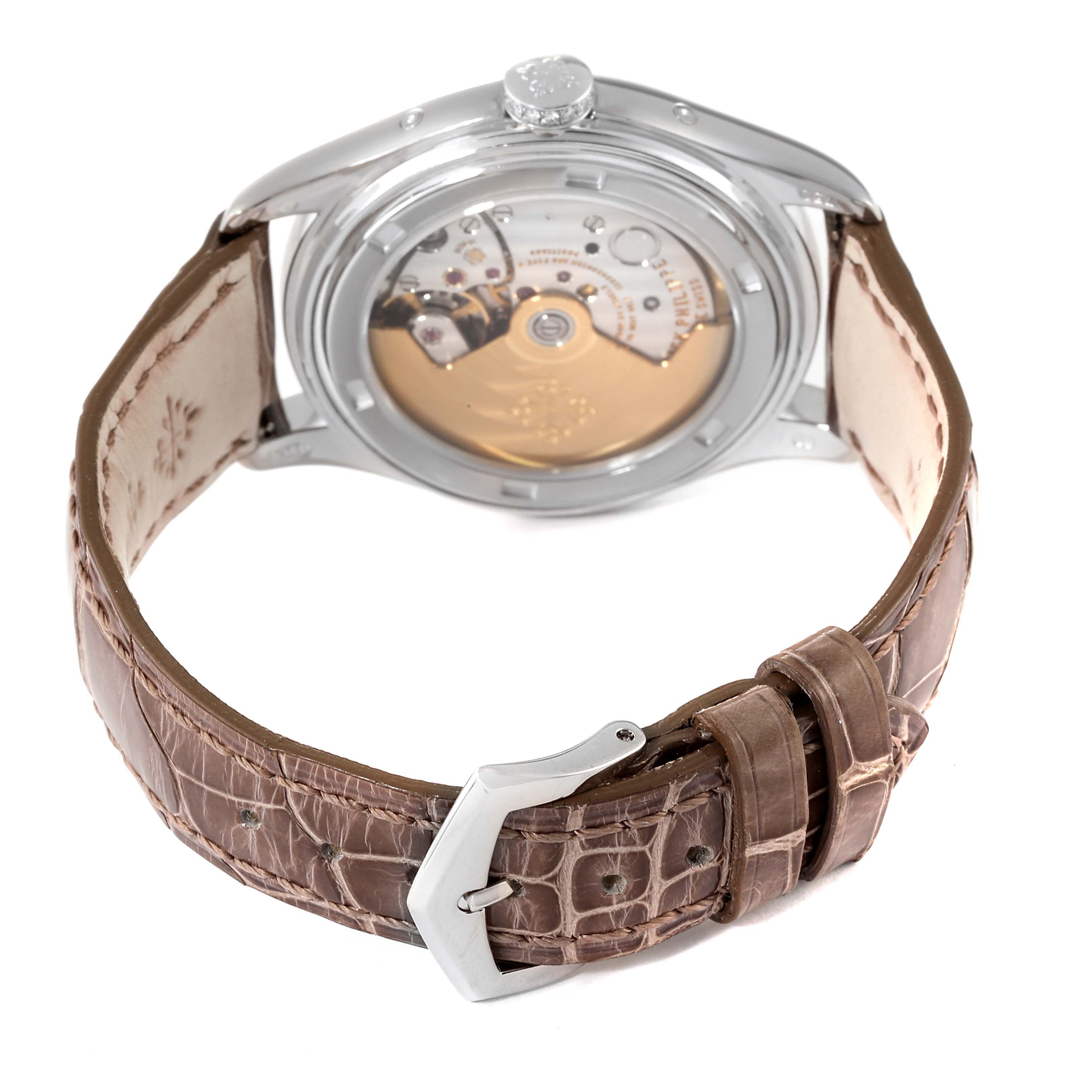 The image shows the back view of the Patek Philippe Complications 4936G - 001 Men's White Gold Mother of Pearl Dial 4936G - 001 Men's White Gold Mother of Pearl Dial model, highlighting the movement and the leather strap with a buckle.