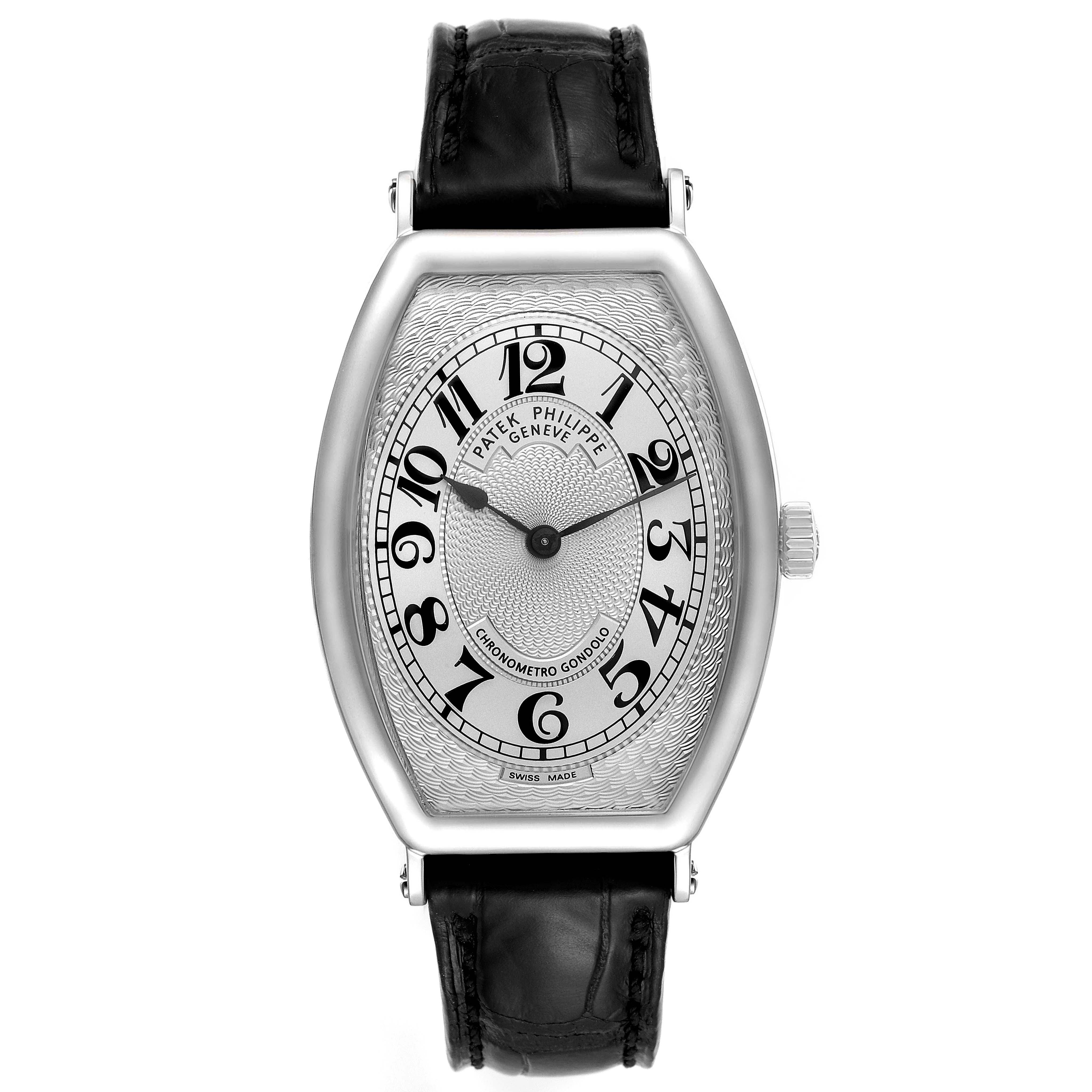 The image shows a front view of Patek Philippe
s Gondolo model watch, featuring a black leather strap and Arabic numerals on its dial.