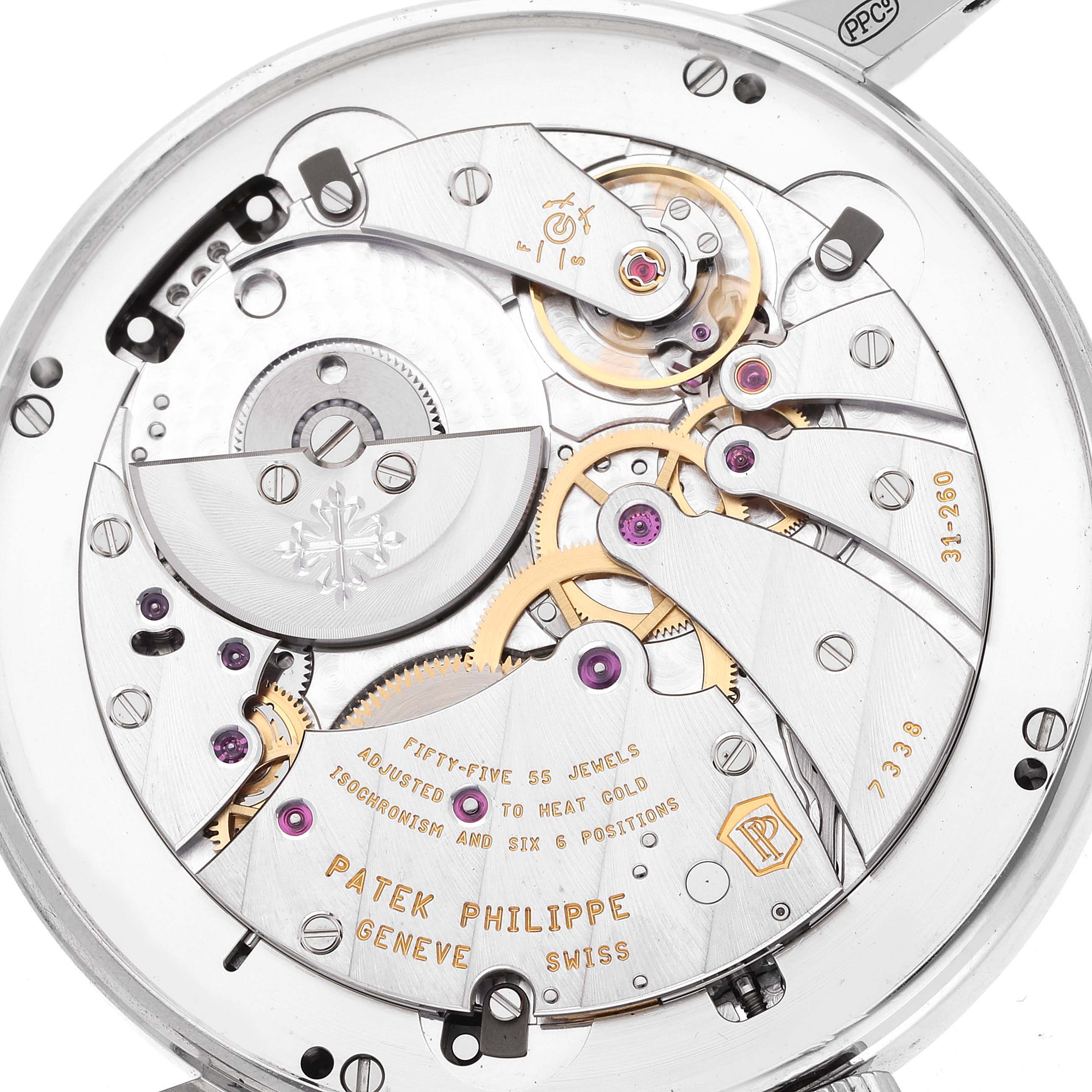 The image shows the intricate movement of a Patek Philippe Complications 5236P Men's Platinum Blue Dial watch from a rear angle, highlighting gears and jewels.