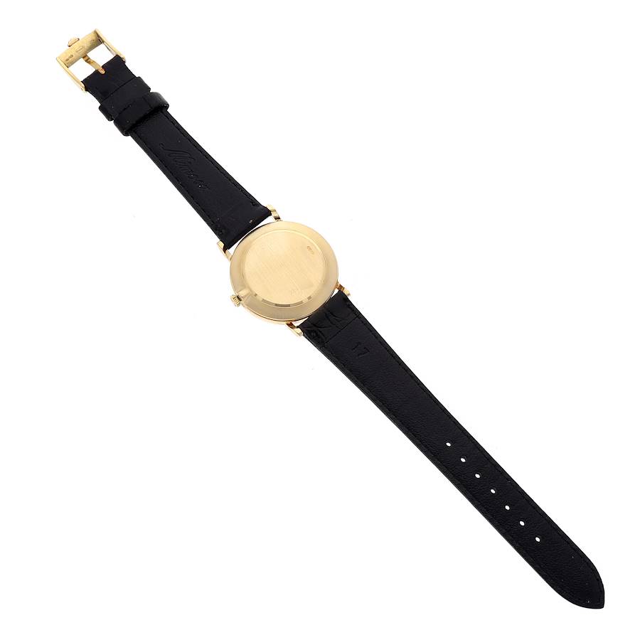 This image shows the back view of a Rolex Cellini 5112 Men's Yellow Gold Mother of Pearl Dial 5112 Men's Yellow Gold Mother of Pearl Dial watch, displaying its gold case and black leather strap.