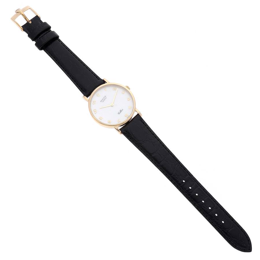 The image shows a Rolex Cellini 5112 Men's Yellow Gold Mother of Pearl Dial 5112 Men's Yellow Gold Mother of Pearl Dial watch with a black leather strap and a gold round dial, viewed from above.