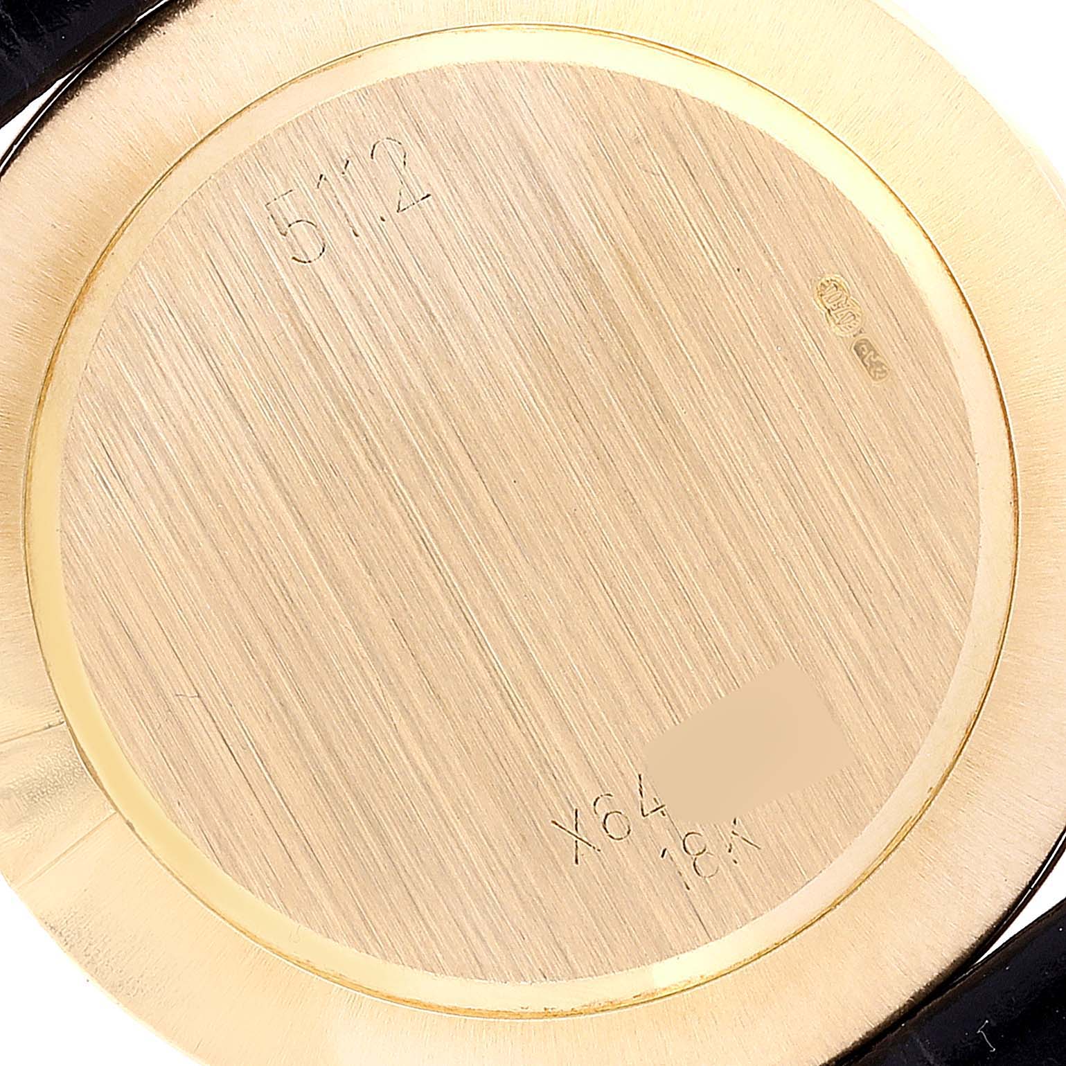This image shows the back case of a Rolex Cellini 5112 Men's Yellow Gold Mother of Pearl Dial 5112 Men's Yellow Gold Mother of Pearl Dial watch, emphasizing the inscriptions and materials used.