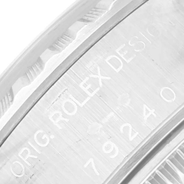 The image shows a close-up of the engraving on the case side of a Rolex Date 79240 Women
s Stainless Steel Silver Dial 79240 Women
s Stainless Steel Silver Dial model watch.