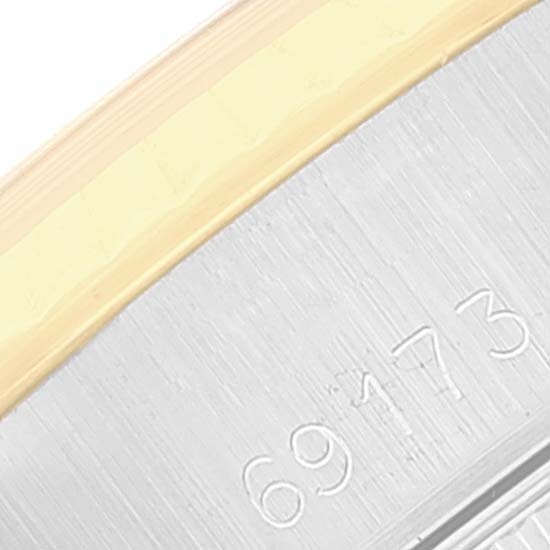 This close-up image of a Rolex Datejust 69173 Women's Steel and Gold (two tone) Champagne Dial 69173 Women's Steel and Gold (two tone) Champagne Dial model shows the side with the model number 69173 and part of the two-tone bezel.