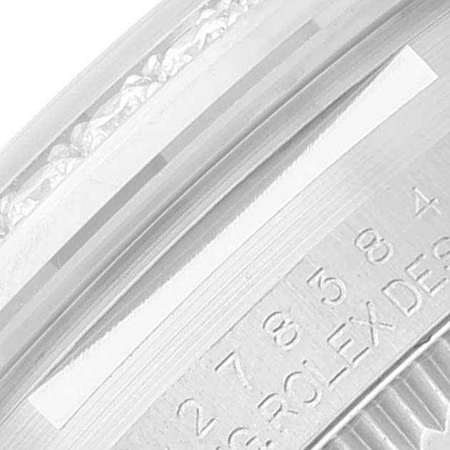 The image shows a close-up of the side of a Rolex Mid-Size 278384 Women's Stainless Steel Mother of Pearl Dial 278384 Women's Stainless Steel Mother of Pearl Dial model, focusing on the bezel and part of the engraving.
