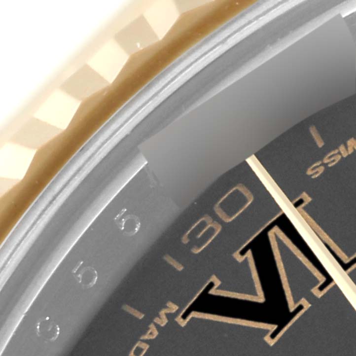 A close-up of the Rolex Datejust 41 116333 Men's Steel and Gold (two tone) Black Dial 116333 Men's Steel and Gold (two tone) Black Dial watch, showing part of the bezel, dial, and minute markers.