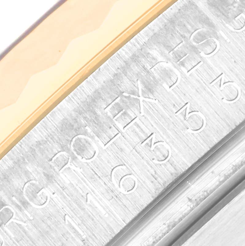 The image shows a close-up angle of the serial number engraving on the rehaut of a Rolex Datejust 41 116333 Men's Steel and Gold (two tone) Black Dial 116333 Men's Steel and Gold (two tone) Black Dial watch.