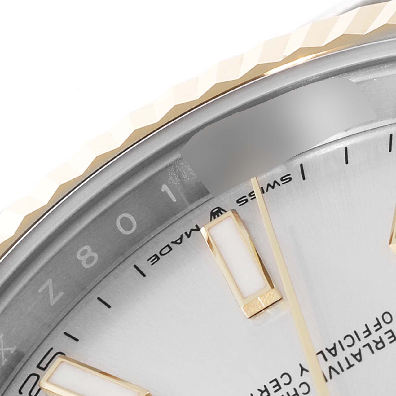 This is a close-up of the Rolex Datejust 41 126333 Men's Steel and Gold (two tone) Silver Dial 126333 Men's Steel and Gold (two tone) Silver Dial watch's dial, focusing on the bezel, hour markers, and part of the minute markings.