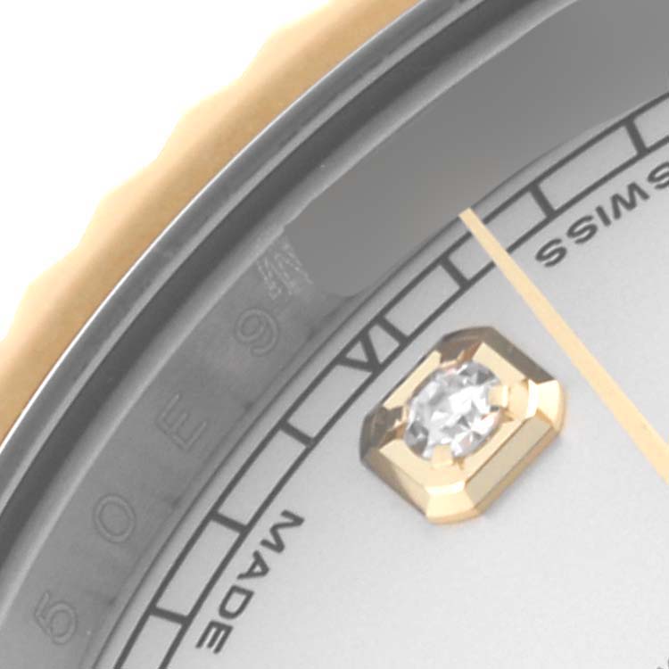 The image shows a close-up of the Rolex Datejust 41 116333 Men's Steel and Gold (two tone) Silver Dial 116333 Men's Steel and Gold (two tone) Silver Dial, focusing on the dial, bezel, and a gold hour marker with a diamond.