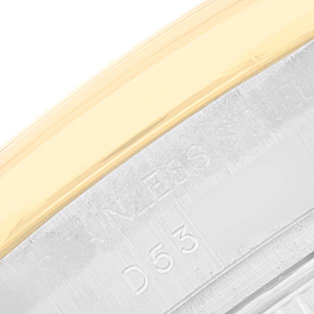 This image shows a close-up of the bezel and part of the caseback with engravings on a Rolex Datejust 179163 Women's Steel and Gold (two tone) Champagne Dial 179163 Women's Steel and Gold (two tone) Champagne Dial watch.