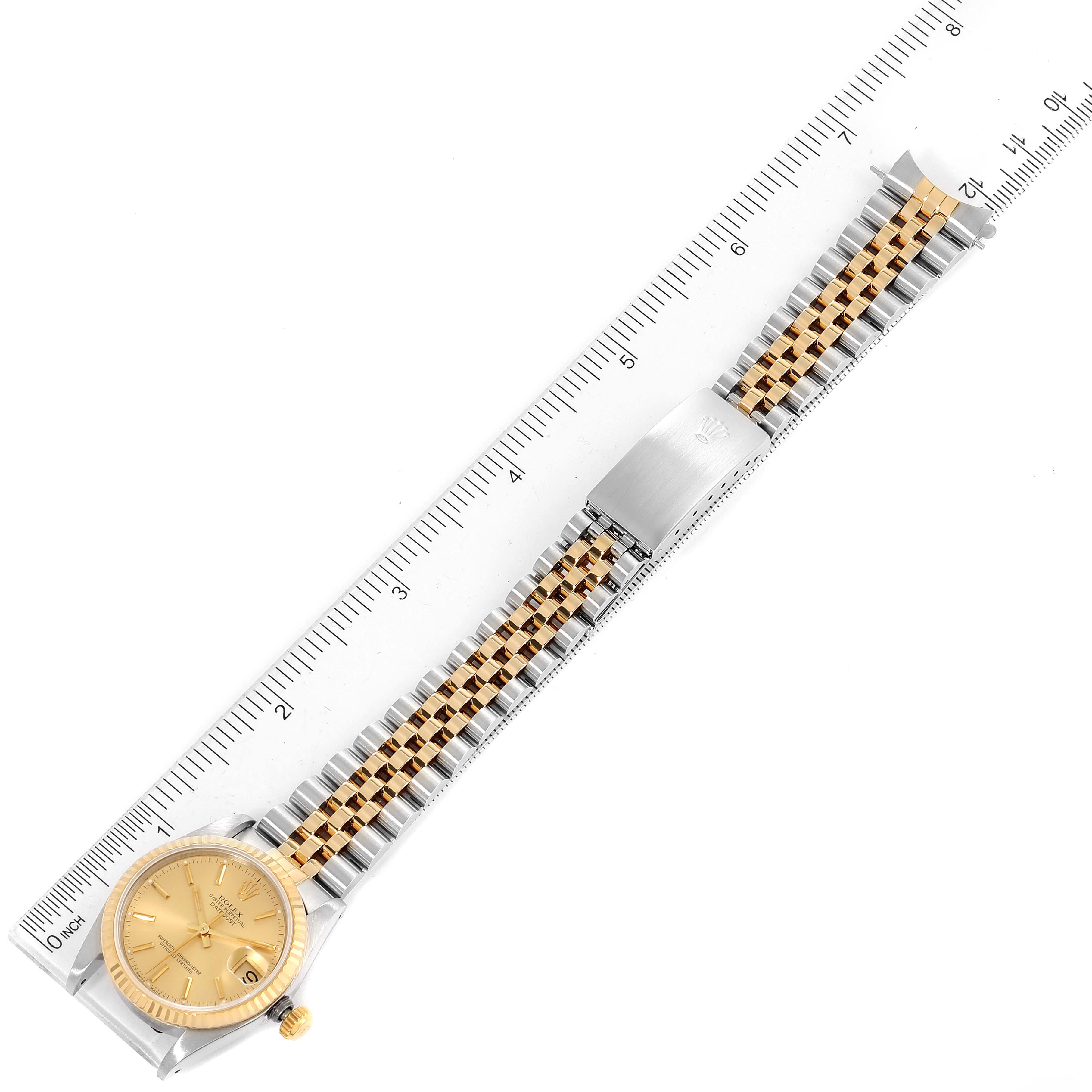 The image shows a Mid-Size Rolex watch laid flat, including the dial, bracelet, and clasp alongside a ruler for size reference.