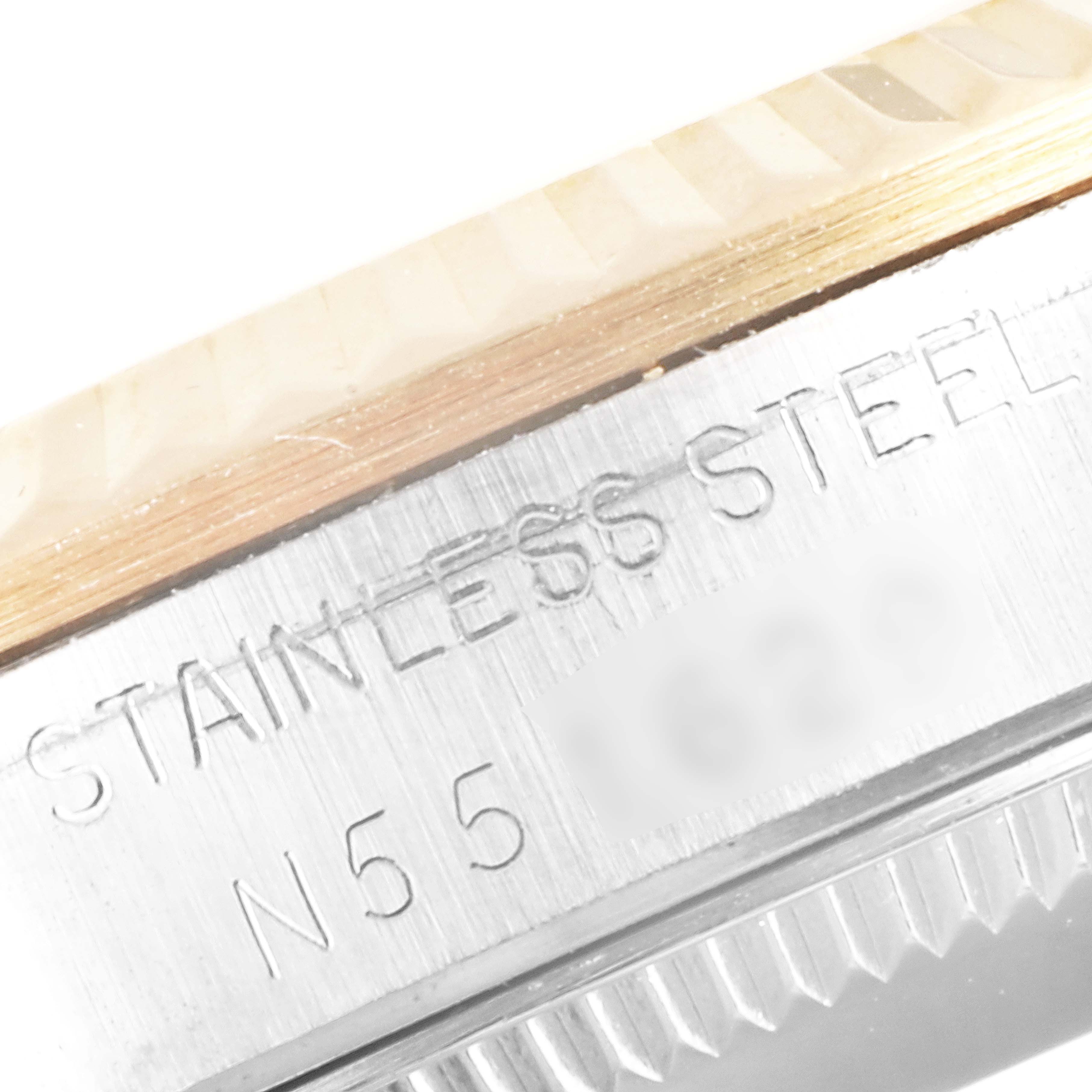 The image shows a close-up of the side of a stainless steel Rolex Mid-Size 68273 Women's Steel and Gold (two tone) Champagne Dial 68273 Women's Steel and Gold (two tone) Champagne Dial watch case with engraved details.