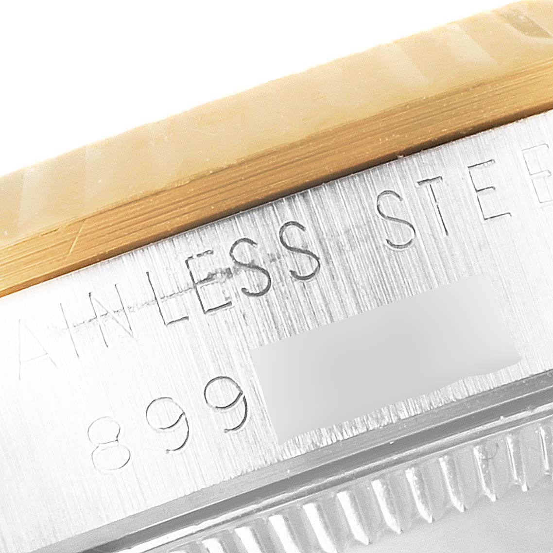 This close-up image shows the engraving on the case side of a Mid-Size Rolex watch.