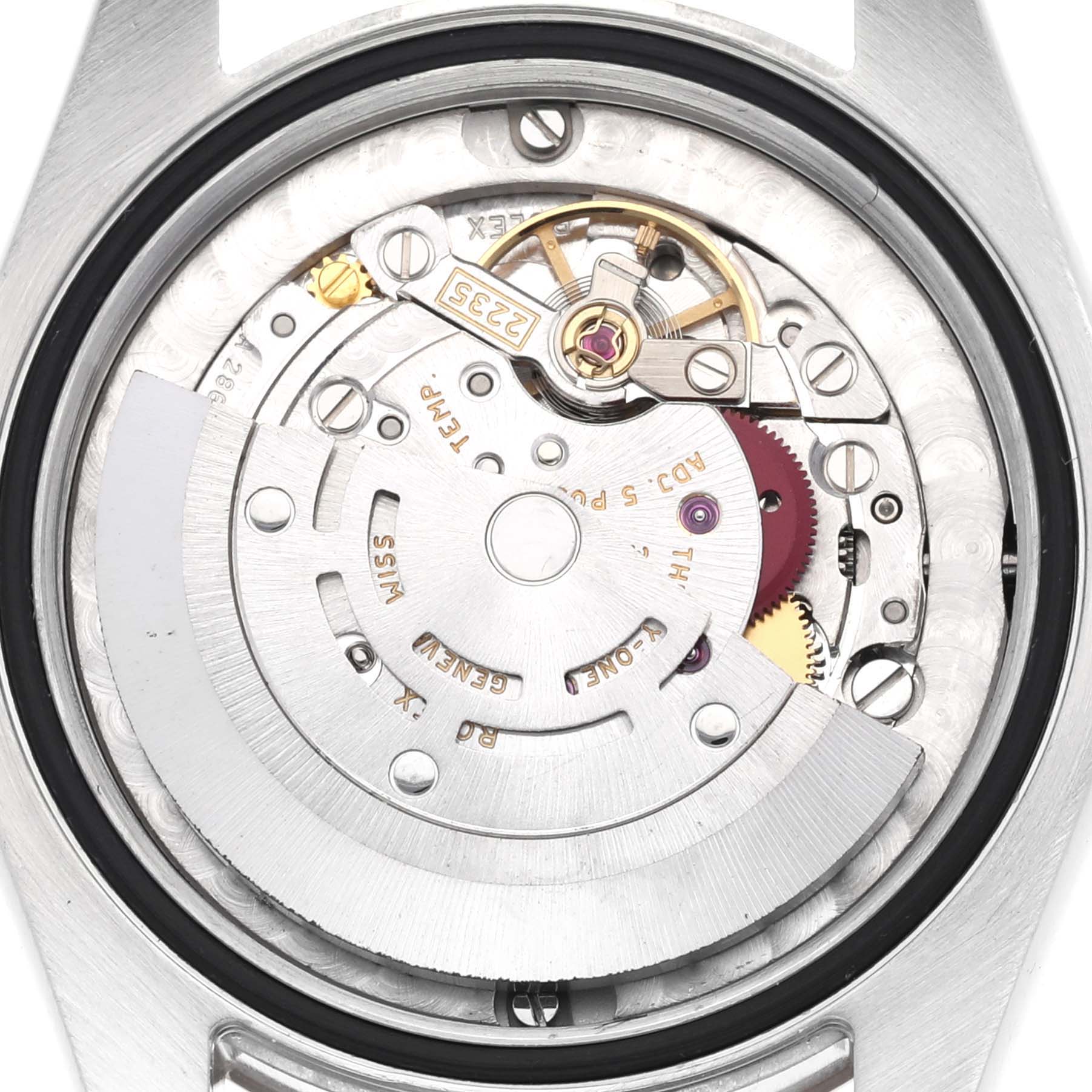 The image shows the movement mechanism of a Mid-Size Rolex watch from a back angle with the rotor, gears, and other intricate parts visible.