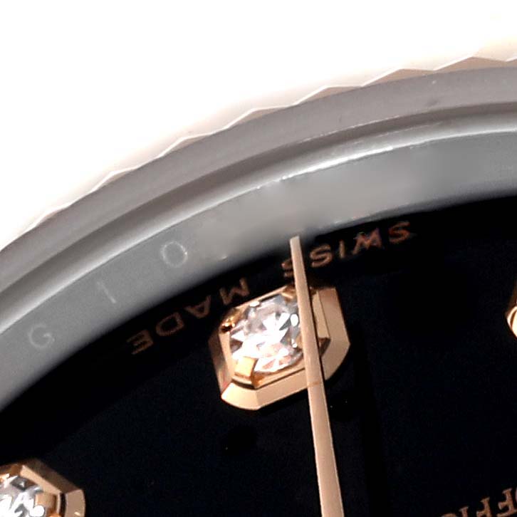 The image shows a close-up of the dial of a Mid-Size Rolex watch, highlighting the diamond hour marker, minute hand, and part of the bezel.