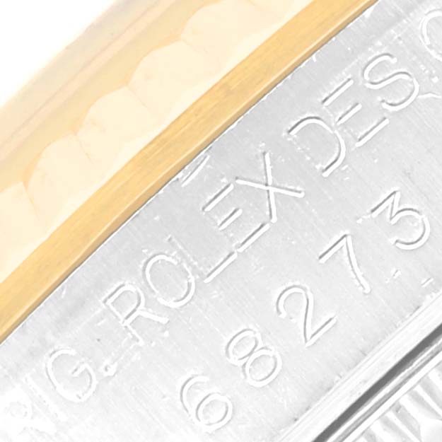 This image shows a close-up of the Rolex Mid-Size 68273 Women's Steel and Gold (two tone) Mother of Pearl Dial 68273 Women's Steel and Gold (two tone) Mother of Pearl Dial model’s case edge and the engraved watch details.