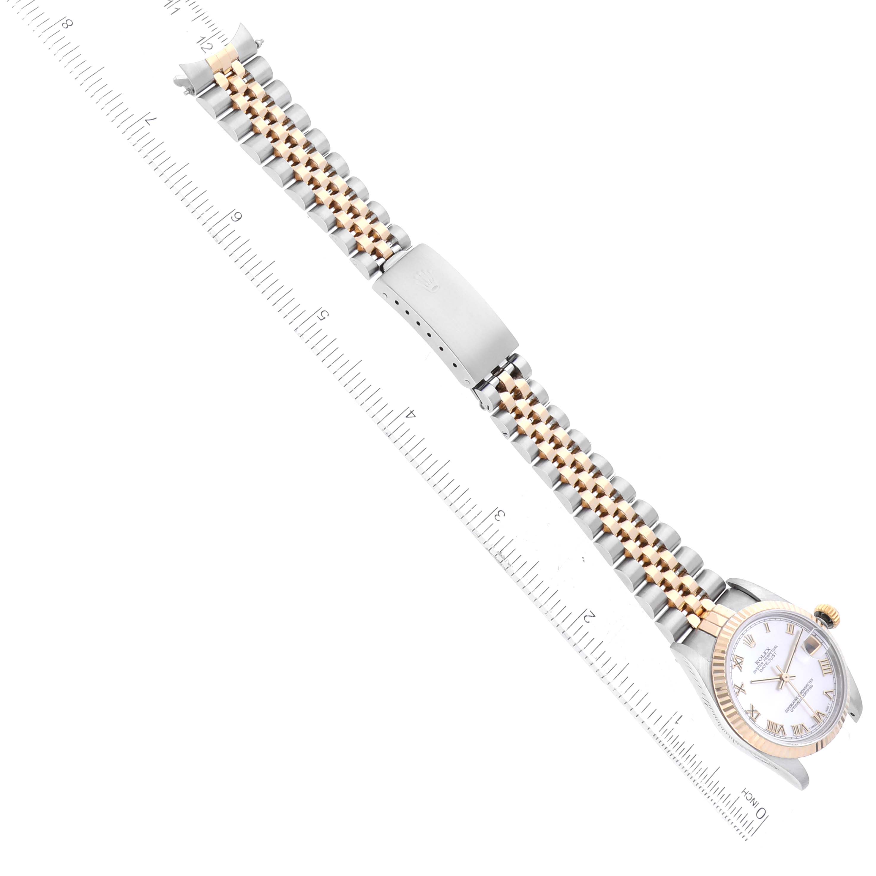The Rolex Mid-Size 68273 Women's Steel and Gold (two tone) Mother of Pearl Dial 68273 Women's Steel and Gold (two tone) Mother of Pearl Dial model is shown from the top, displaying its two-tone bracelet, clasp, and part of the watch face next to a ruler.