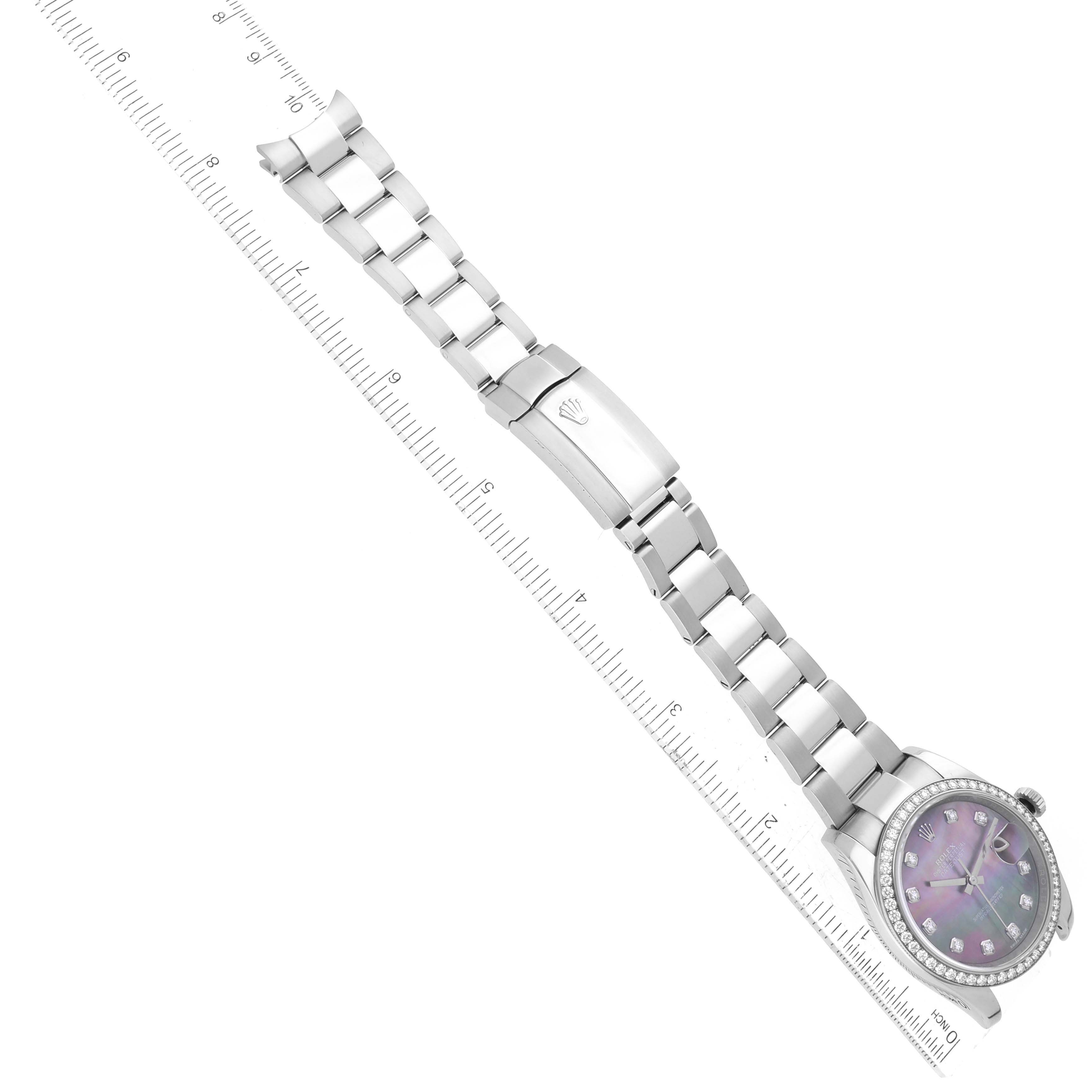 The image shows a Rolex Datejust 116244 Men's Stainless Steel Mother of Pearl Dial 116244 Men's Stainless Steel Mother of Pearl Dial watch laid flat with a clear view of the band, clasp, and face alongside a ruler.