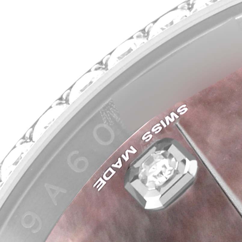 The image is a close-up of the bezel, dial, and a diamond marker on a Rolex Datejust 116244 Men's Stainless Steel Mother of Pearl Dial 116244 Men's Stainless Steel Mother of Pearl Dial watch, showing the "SWISS MADE" inscription.