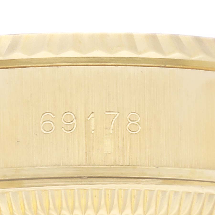 This close-up shows the serial number engraved on the side of the gold case for the Rolex President 69178 Women's Yellow Gold Champagne Dial 69178 Women's Yellow Gold Champagne Dial model 69178 watch.