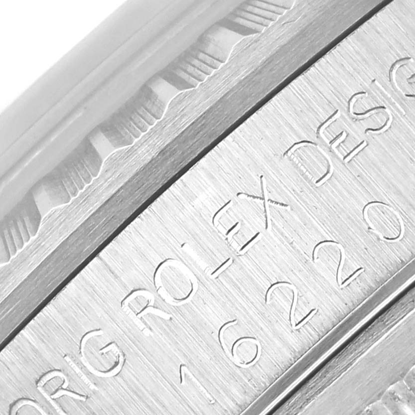 The image shows a macro close-up of the engraved reference number and part of the bezel of a Rolex Datejust 16220 Men's Stainless Steel Silver Dial 16220 Men's Stainless Steel Silver Dial watch.