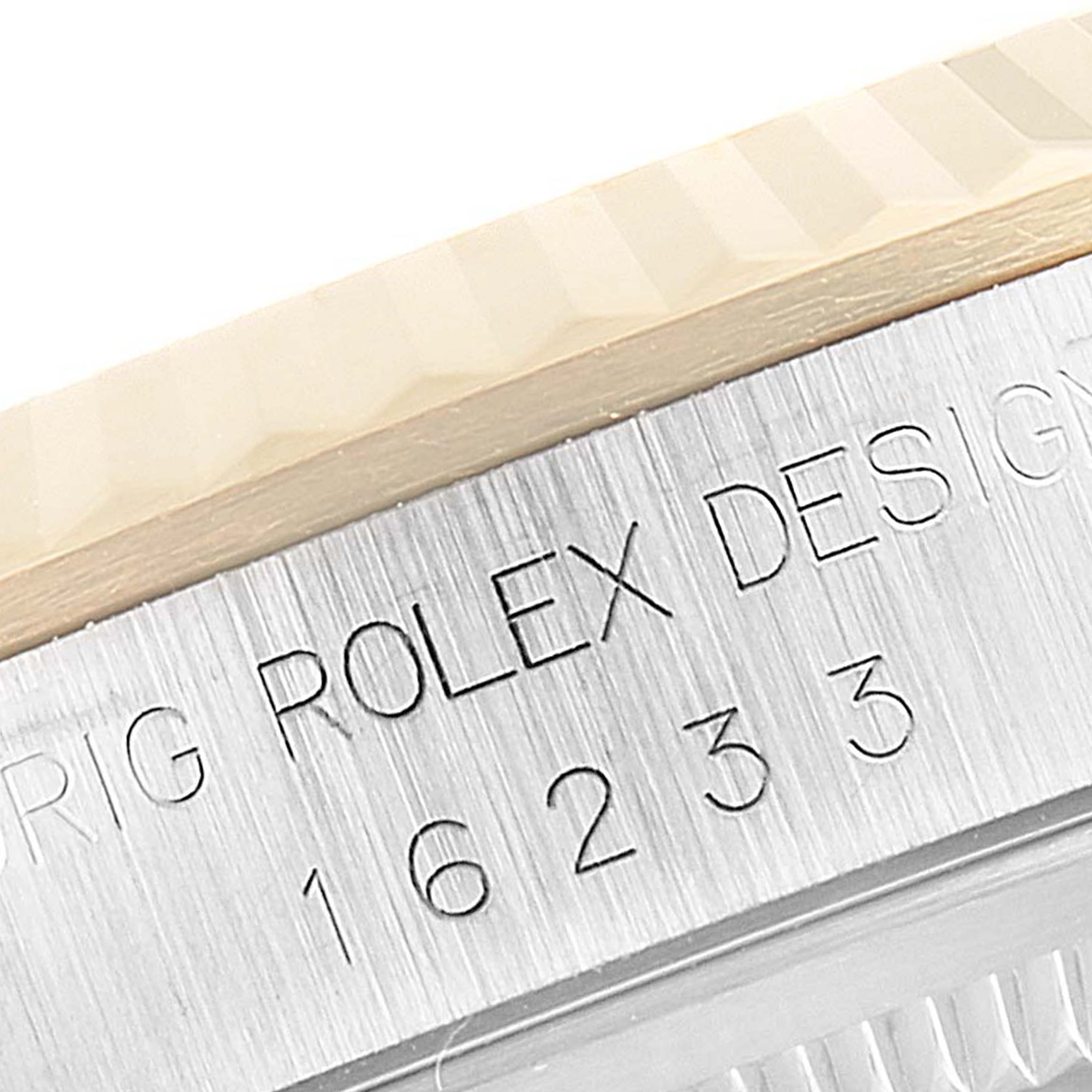 This image shows a close-up of the serial number and part of the bezel for a Rolex Datejust 16233 Men's Steel and Gold (two tone) Champagne Dial 16233 Men's Steel and Gold (two tone) Champagne Dial watch.