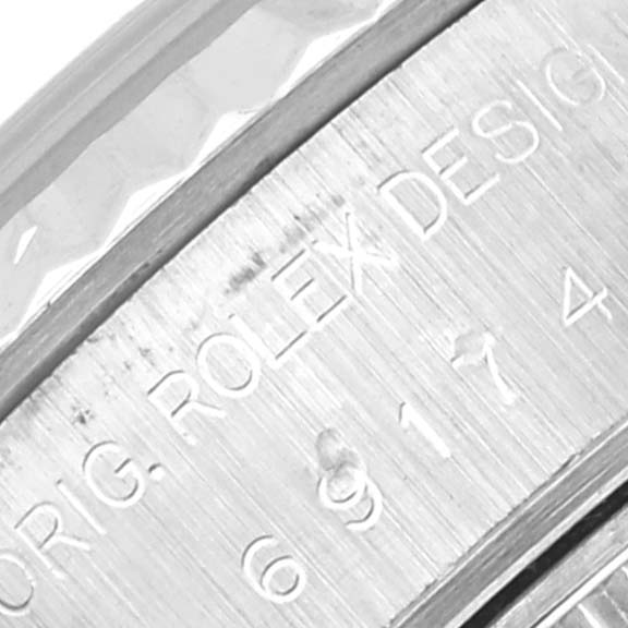 This image shows a close-up of the engraved bezel on a Rolex Datejust 69174 Women's Stainless Steel Silver Dial 69174 Women's Stainless Steel Silver Dial watch.
