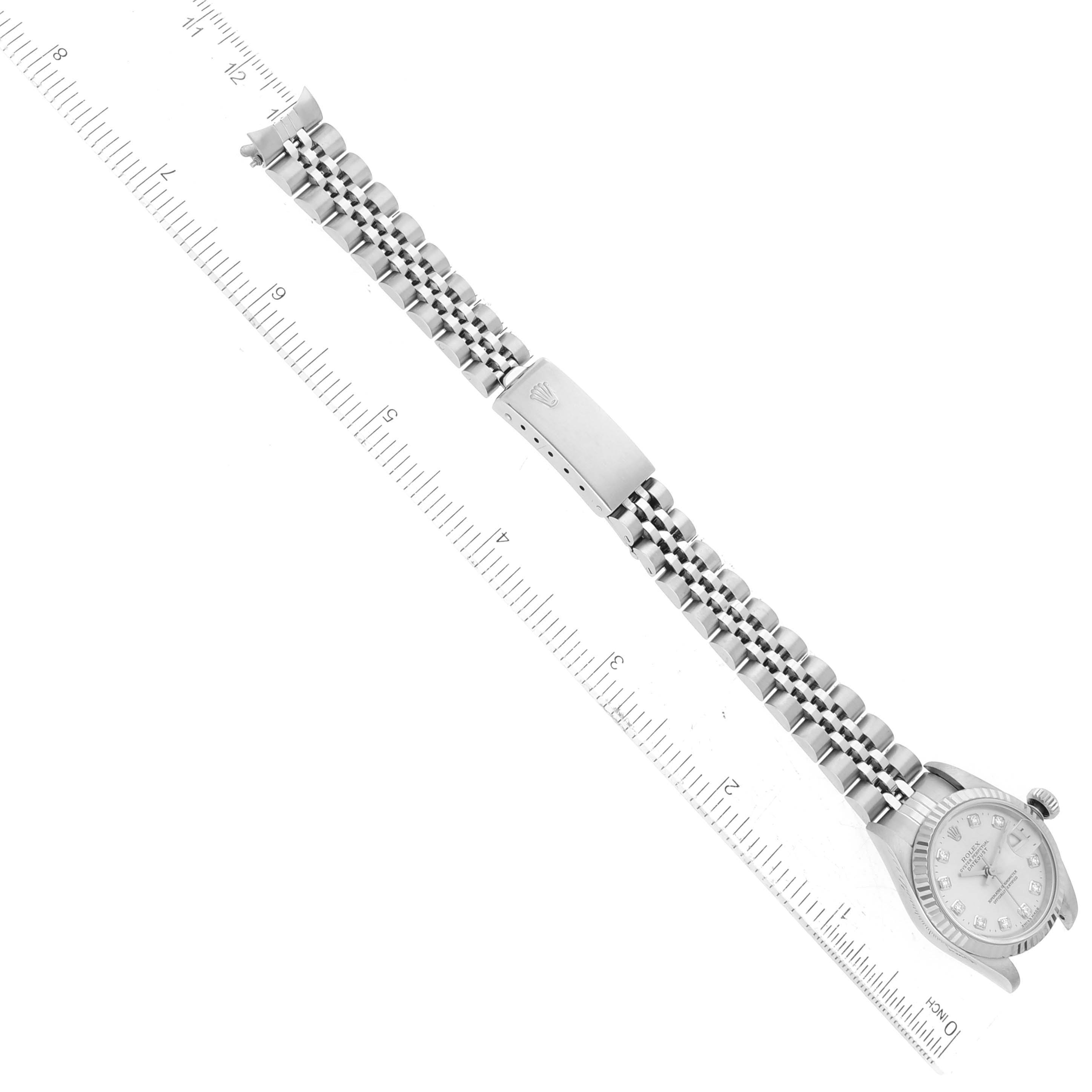 The image shows a Rolex Datejust 69174 Women's Stainless Steel Silver Dial 69174 Women's Stainless Steel Silver Dial watch, specifically the face, band, clasp, and crown viewed from an angled top-down perspective beside a ruler.