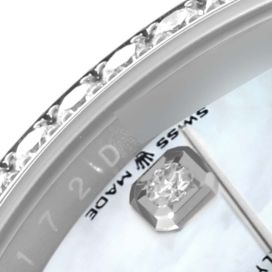This close-up image of the Rolex Datejust 126284 Men's Stainless Steel Mother of Pearl Dial 126284 Men's Stainless Steel Mother of Pearl Dial watch shows its bezel with embedded diamonds and part of the dial and crown logo.