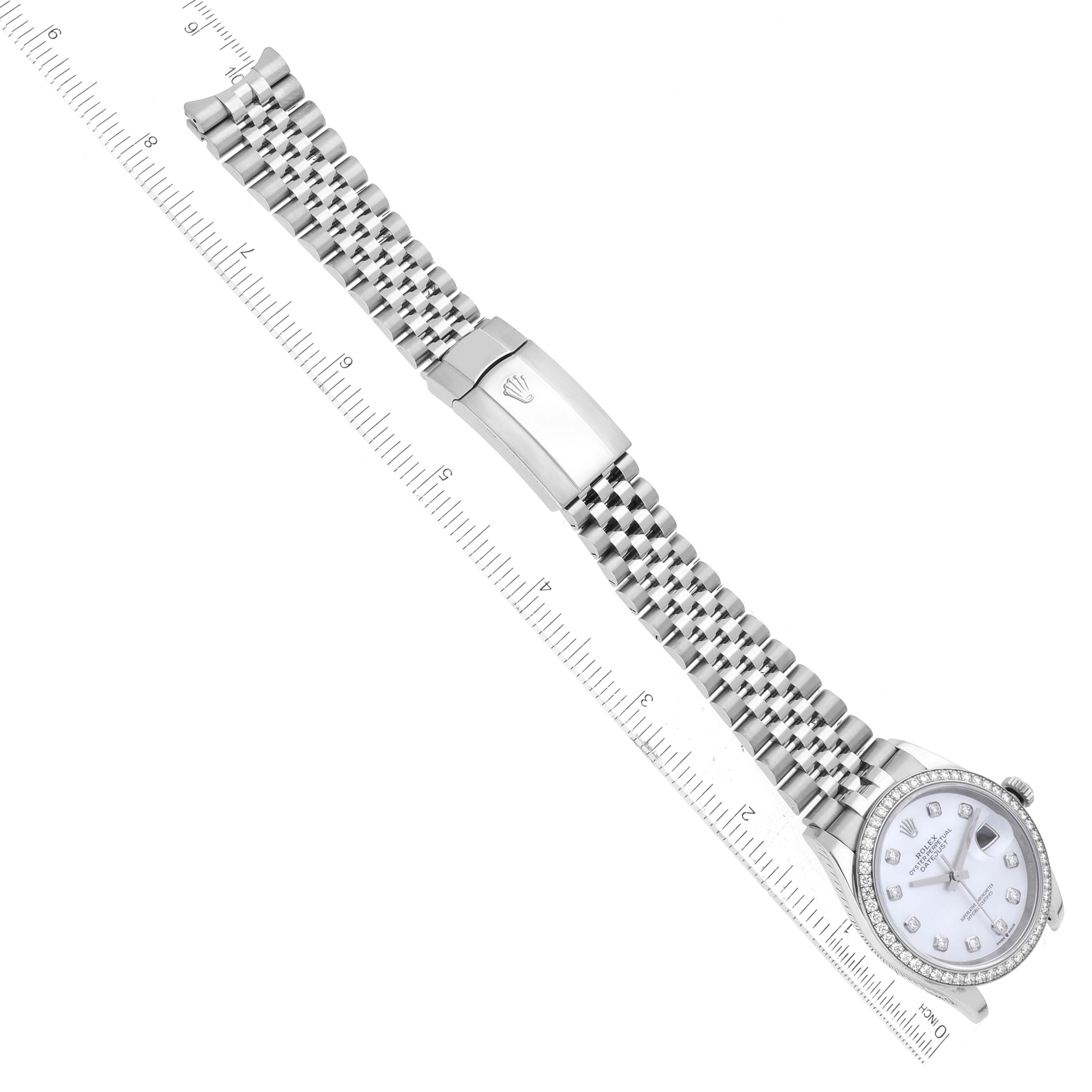 The image shows a top-down view of a Rolex Datejust 126284 Men's Stainless Steel Mother of Pearl Dial 126284 Men's Stainless Steel Mother of Pearl Dial watch, displaying the entire watch with its face, bezel, and bracelet along a ruler.