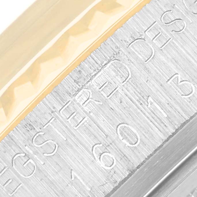 This close-up shows the engraved details on the metal casing and the edge of the bezel of the Rolex Vintage Collection 16013 Men's Steel and Gold (two tone) Champagne Dial 16013 Men's Steel and Gold (two tone) Champagne Dial watch.