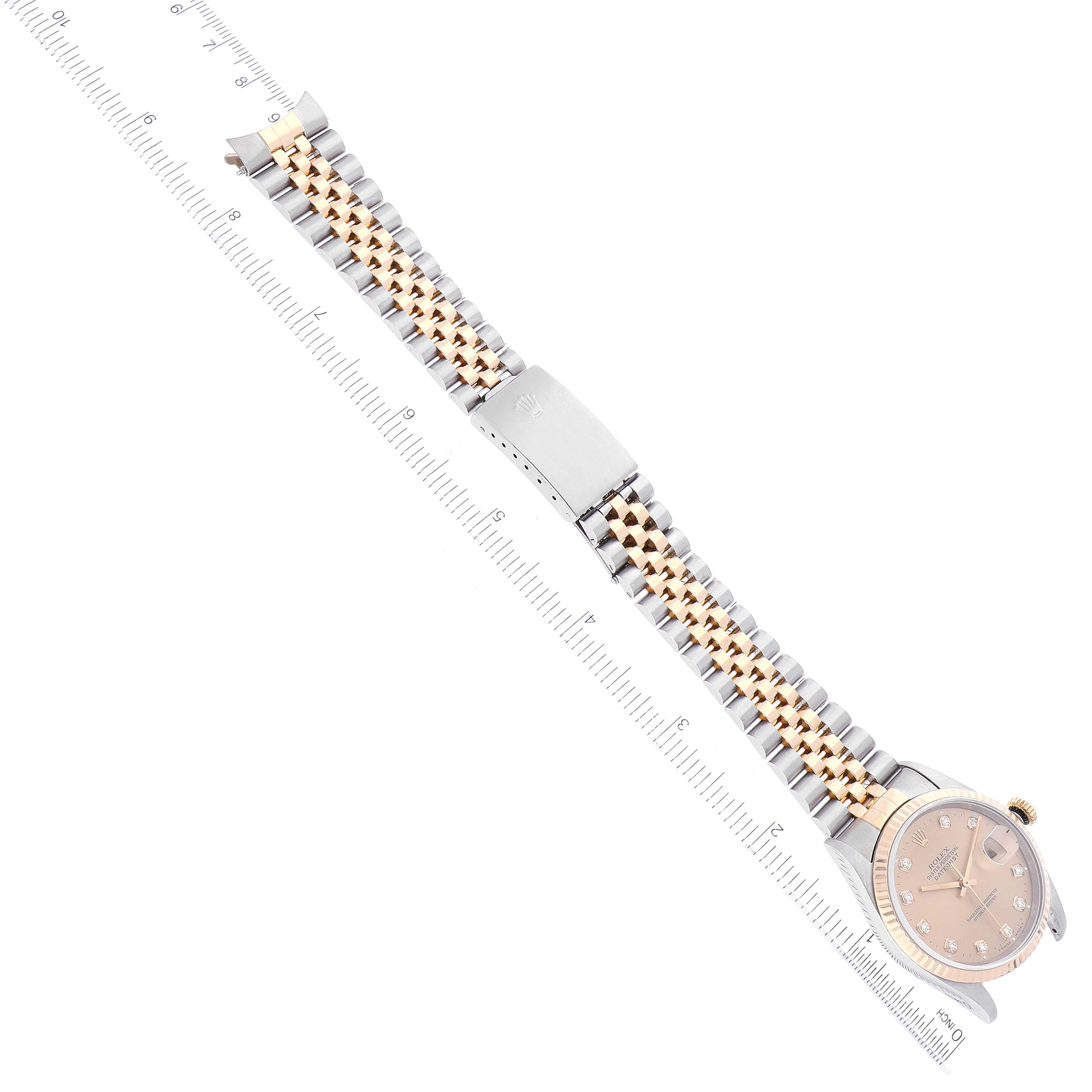 The image shows a Rolex Datejust 16233 Men's Steel and Gold (two tone) Champagne Dial 16233 Men's Steel and Gold (two tone) Champagne Dial watch laid out flat with its dial and bi-color bracelet visible next to a ruler.
