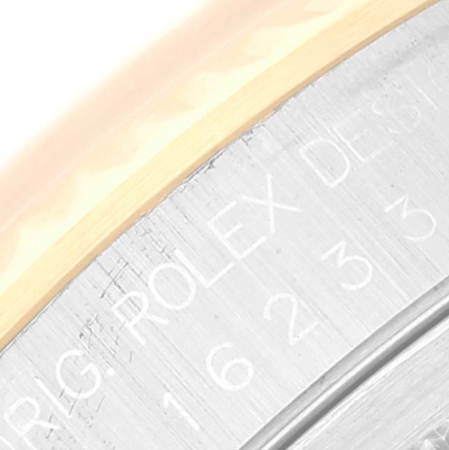 The image shows an angled close-up of the engravings on the back of the Rolex Datejust 16233 Men's Steel and Gold (two tone) Champagne Dial 16233 Men's Steel and Gold (two tone) Champagne Dial watch case.