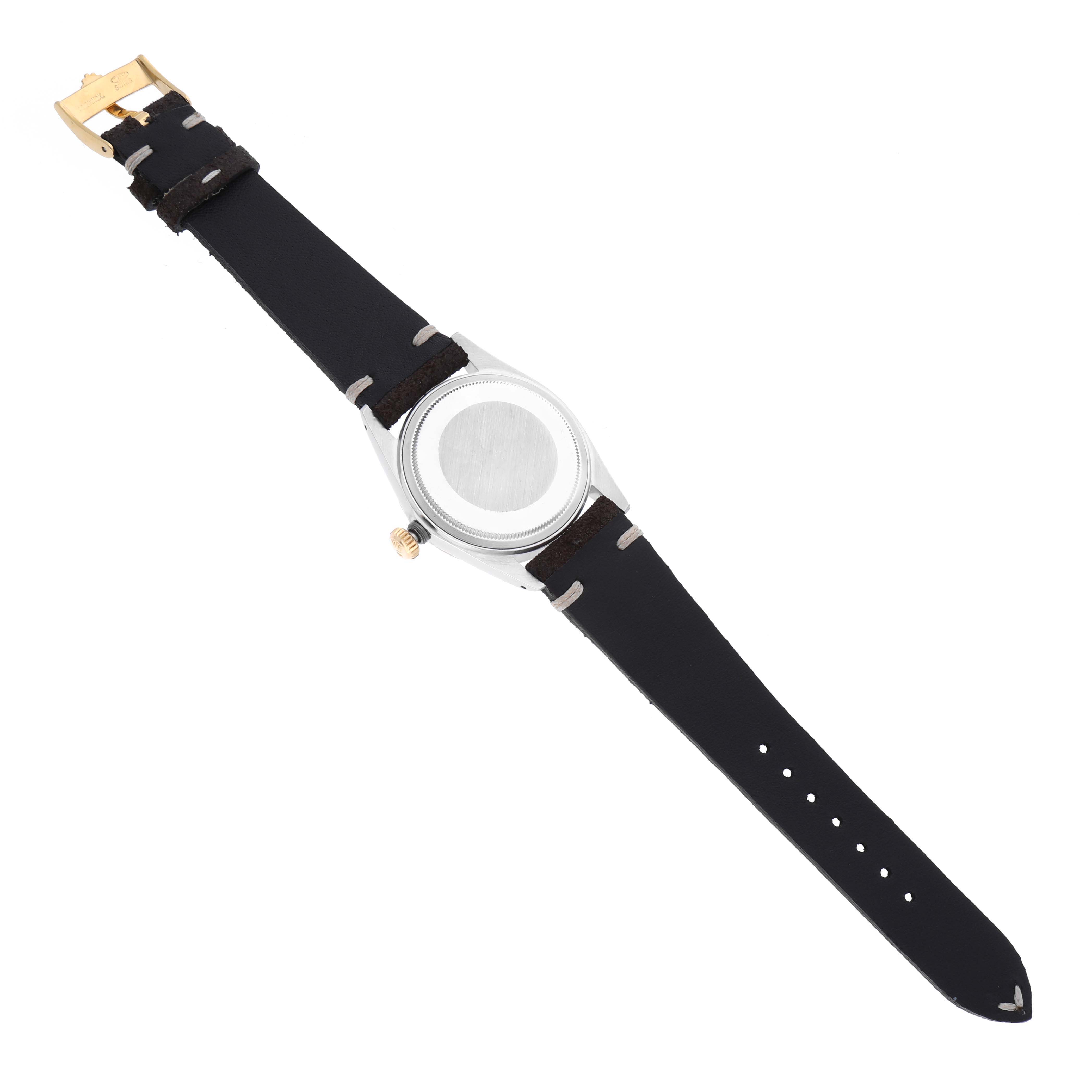 The image shows the back view of a Vintage Collection Rolex watch, highlighting its black leather strap and metal case back.